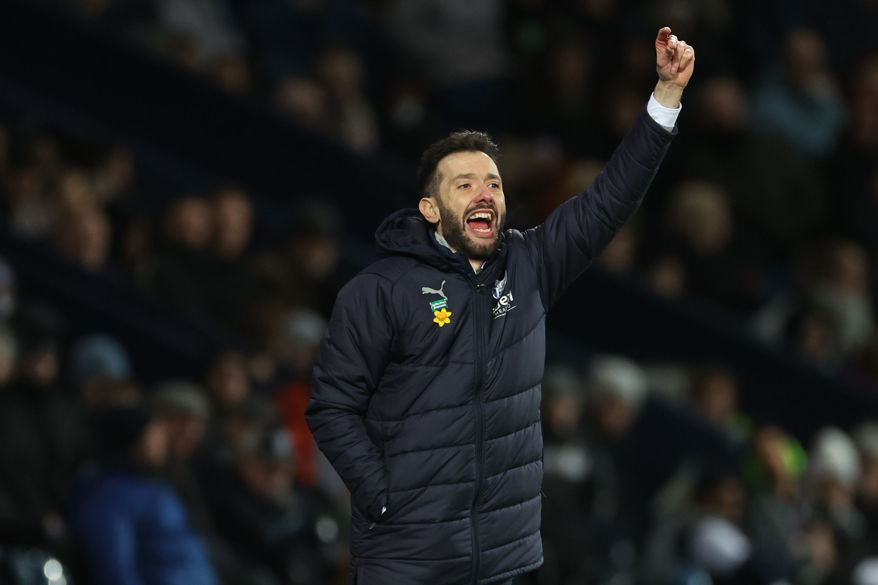 Carlos Corberán with his arm in the air on the touchline against Coventry 