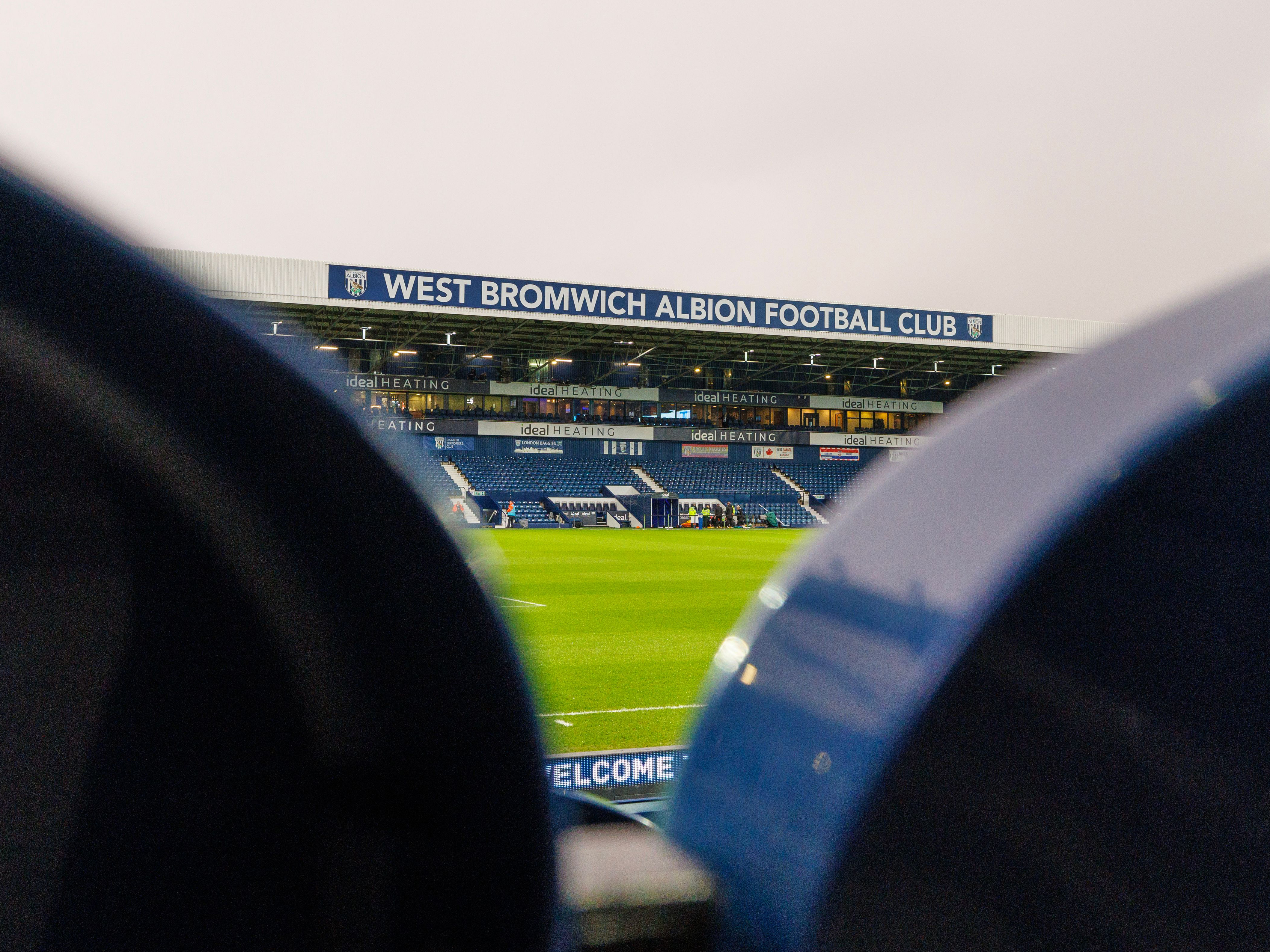 A general view of the West Stand at The Hawthorns from between two seats in the East Stand 