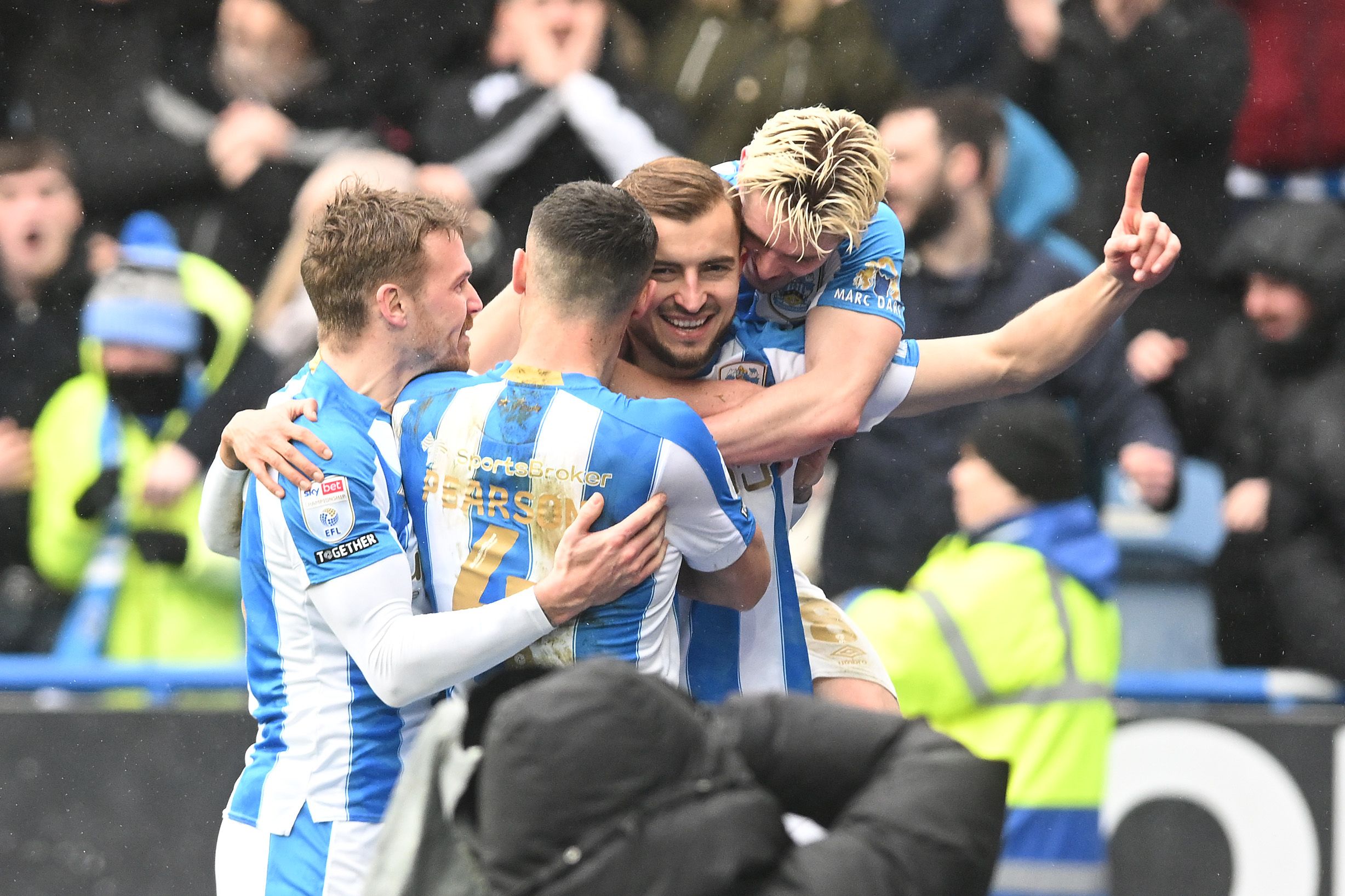 Huddersfield Town players celebrate together after scoring against Leeds
