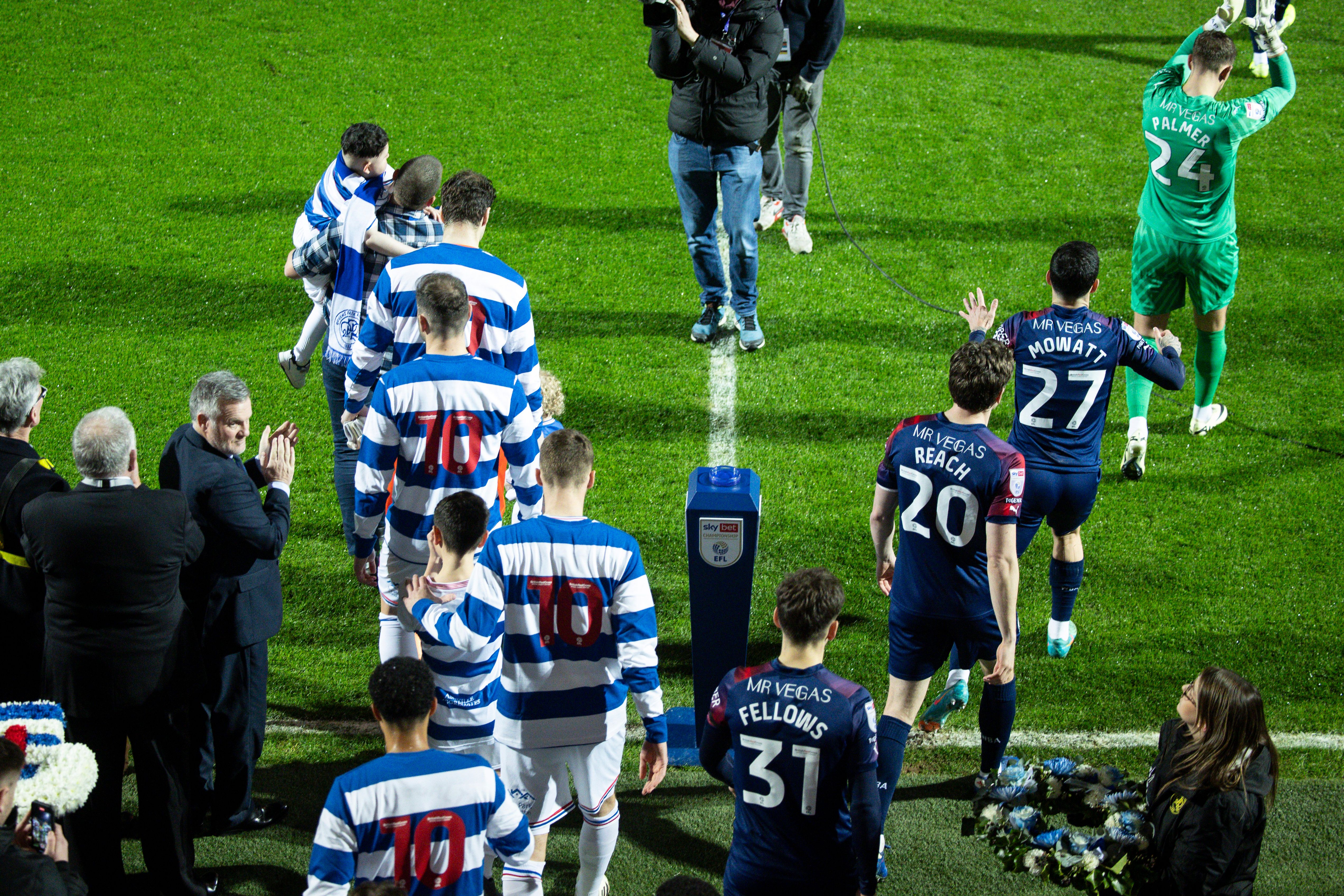 QPR and Albion players walk out on to the pitch before the game at Loftus Road