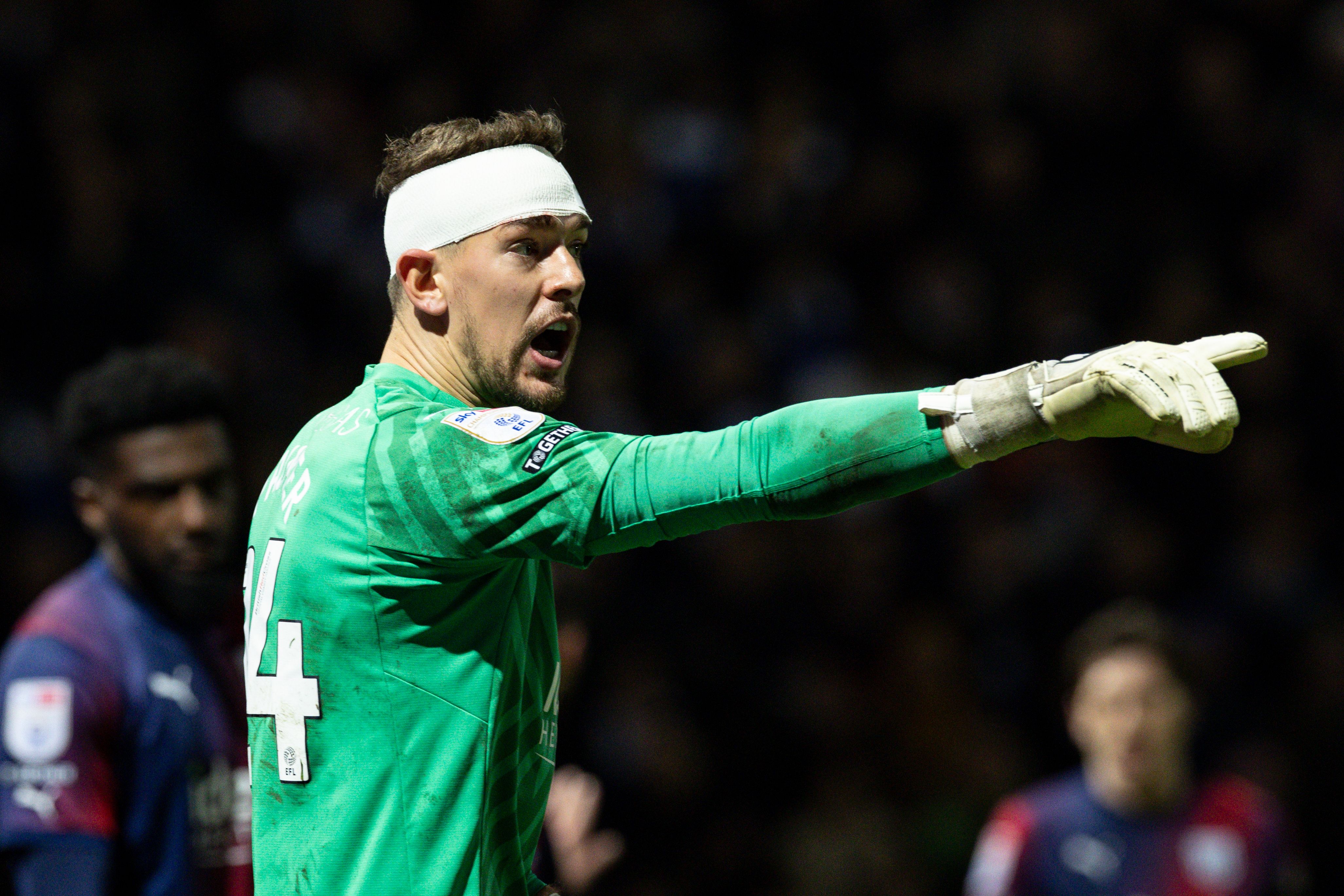 Alex Palmer pointing during the game against QPR while wearing a bandage around his head