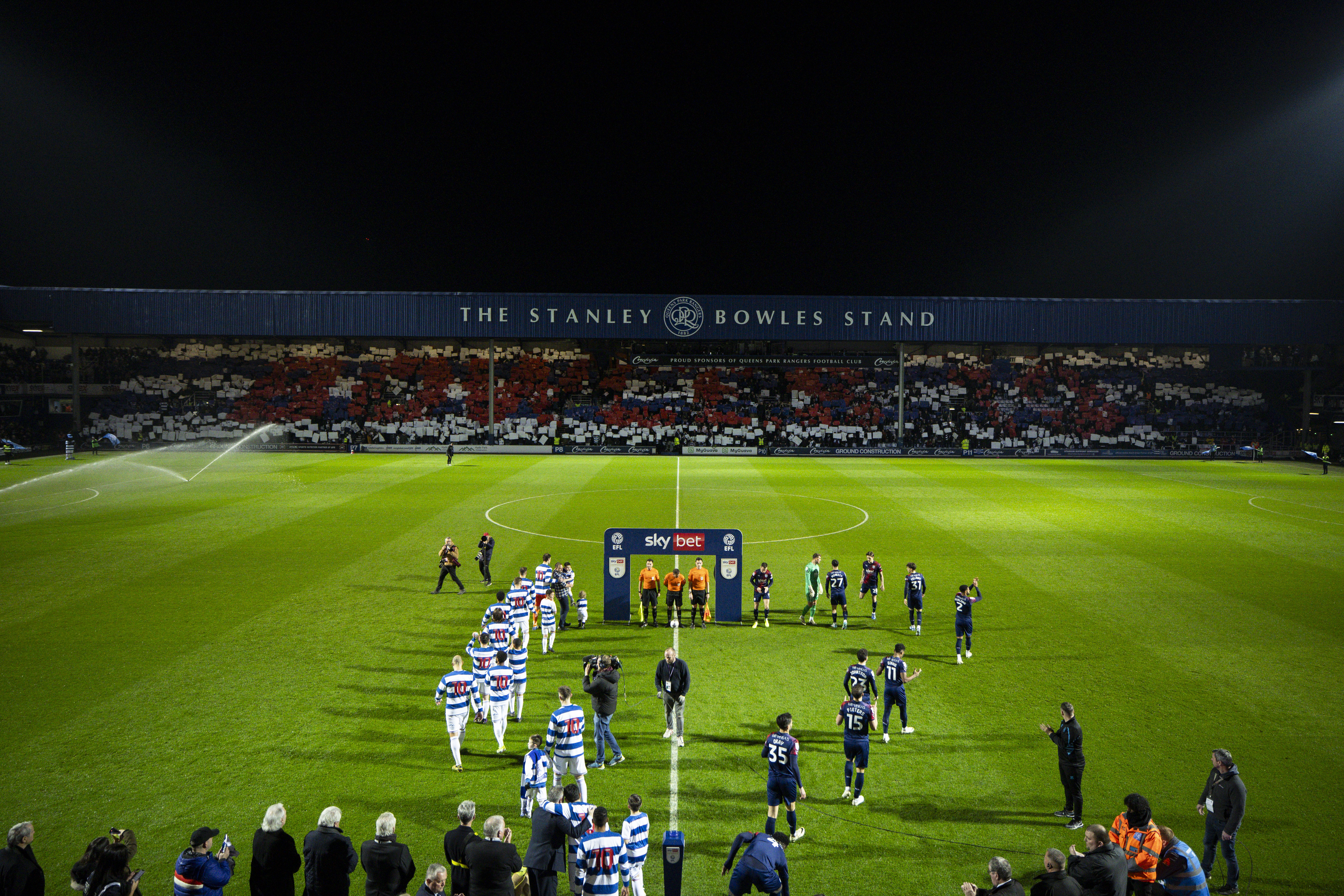 QPR and Albion players walk out on to the pitch before the game at Loftus Road