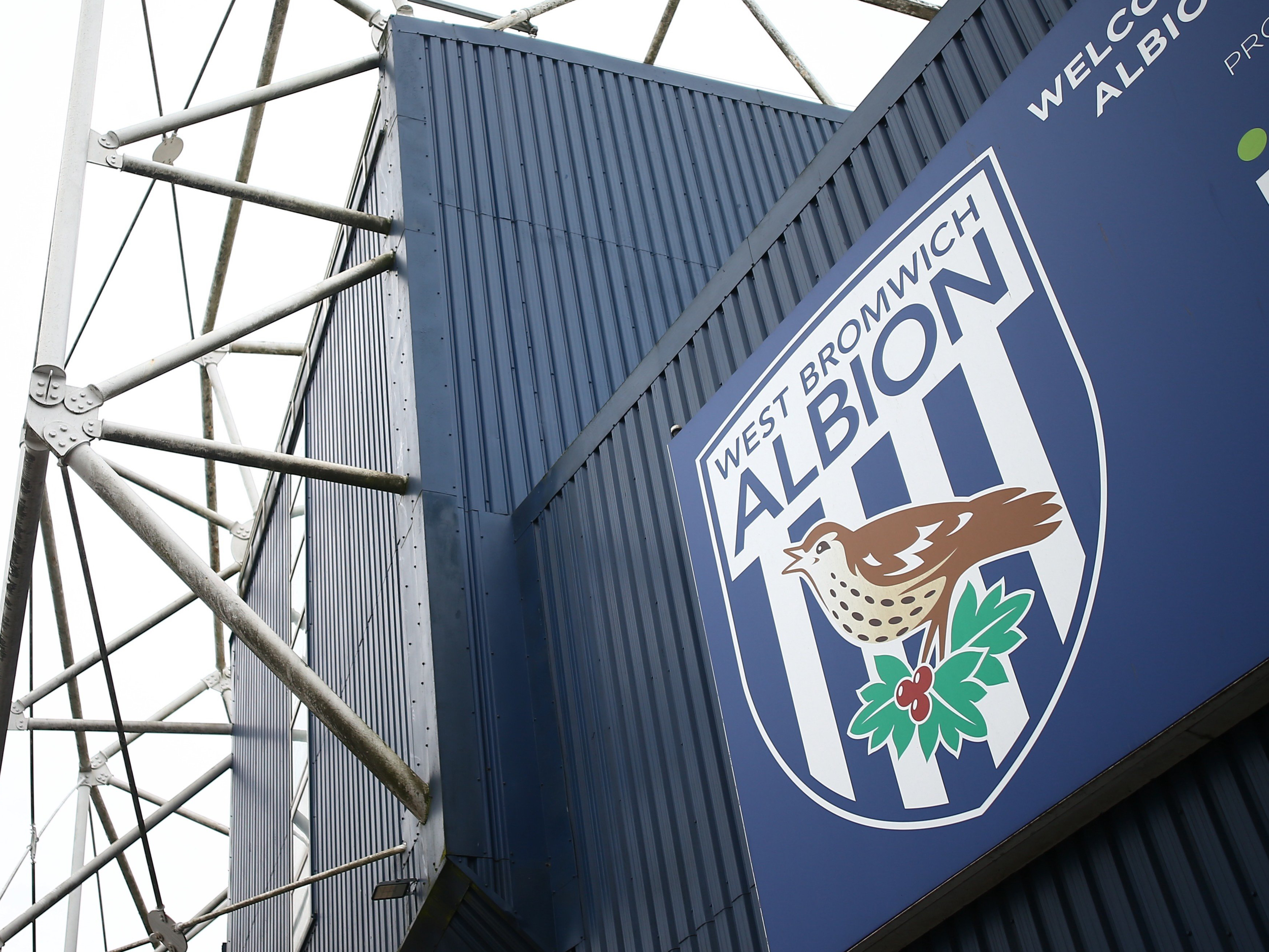 A general view of the outside of The Hawthorns with a big WBA badge on the side of the stand