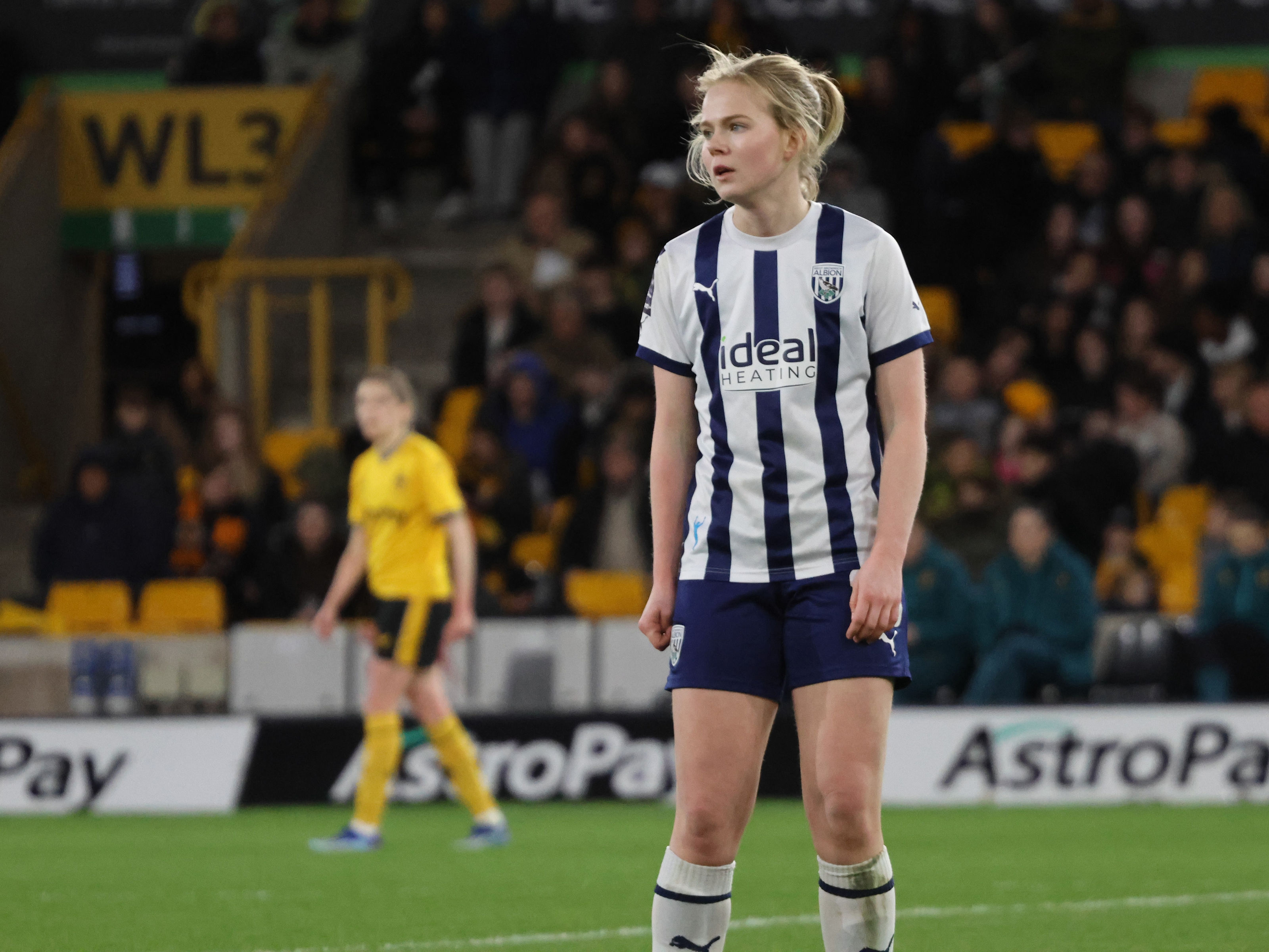 An image of Phoebe Warner stood in the middle of the pitch at Molineux
