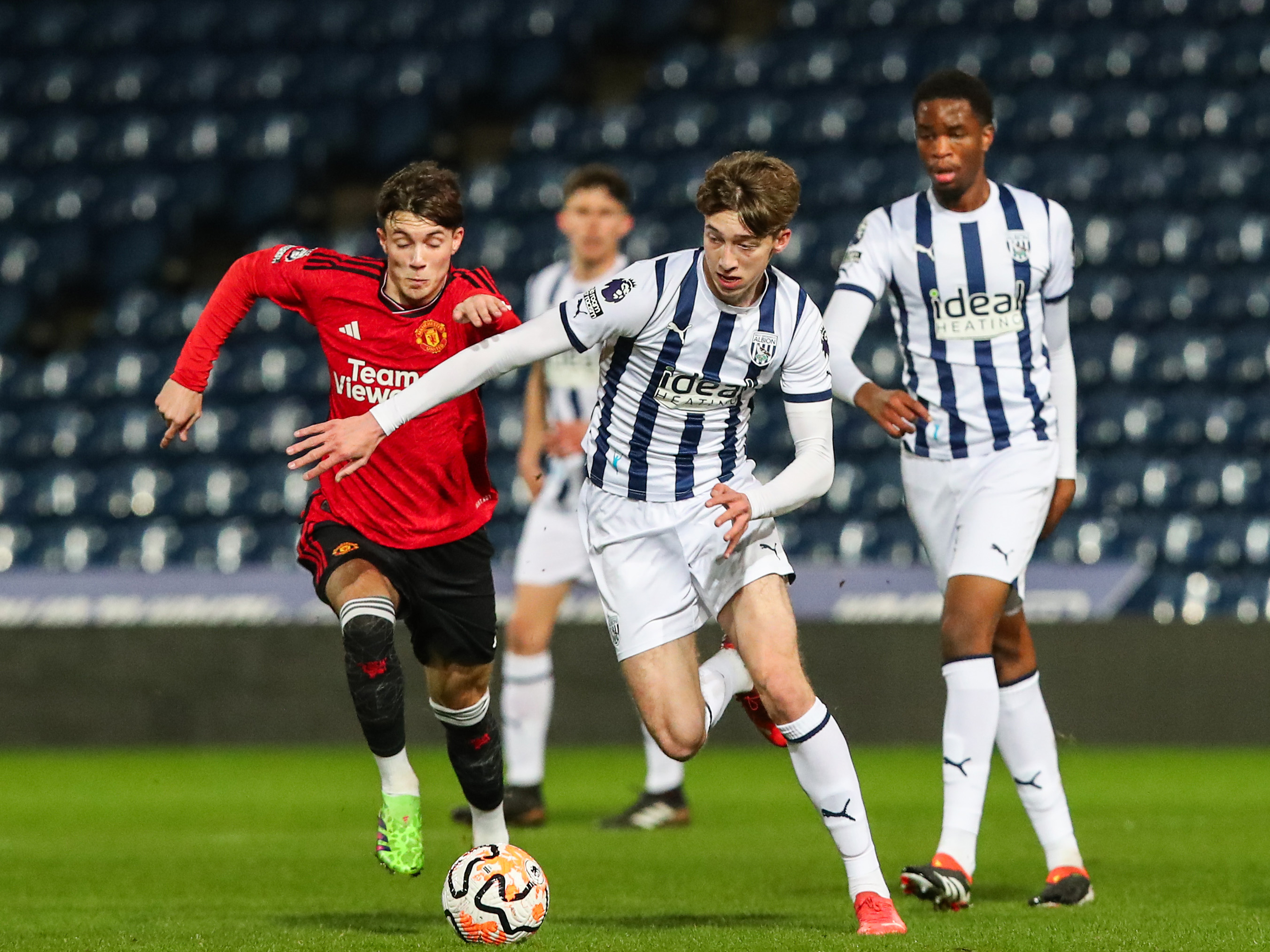 Harry Whitwell battles for the ball with a Manchester United player during the PL2 clash at The Hawthorns
