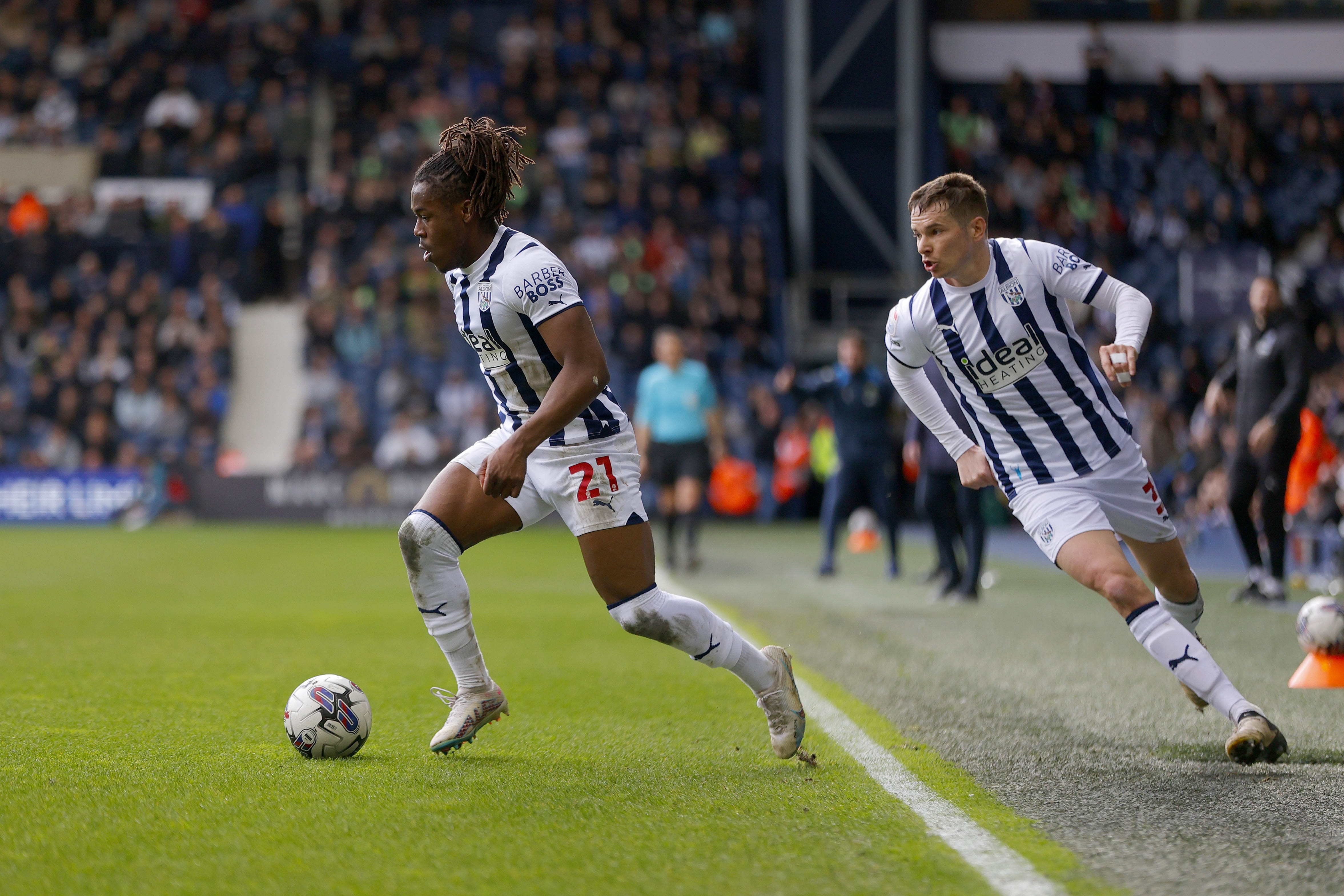 Brandon Thomas-Asante running with the ball against Watford with Conor Townsend behind him