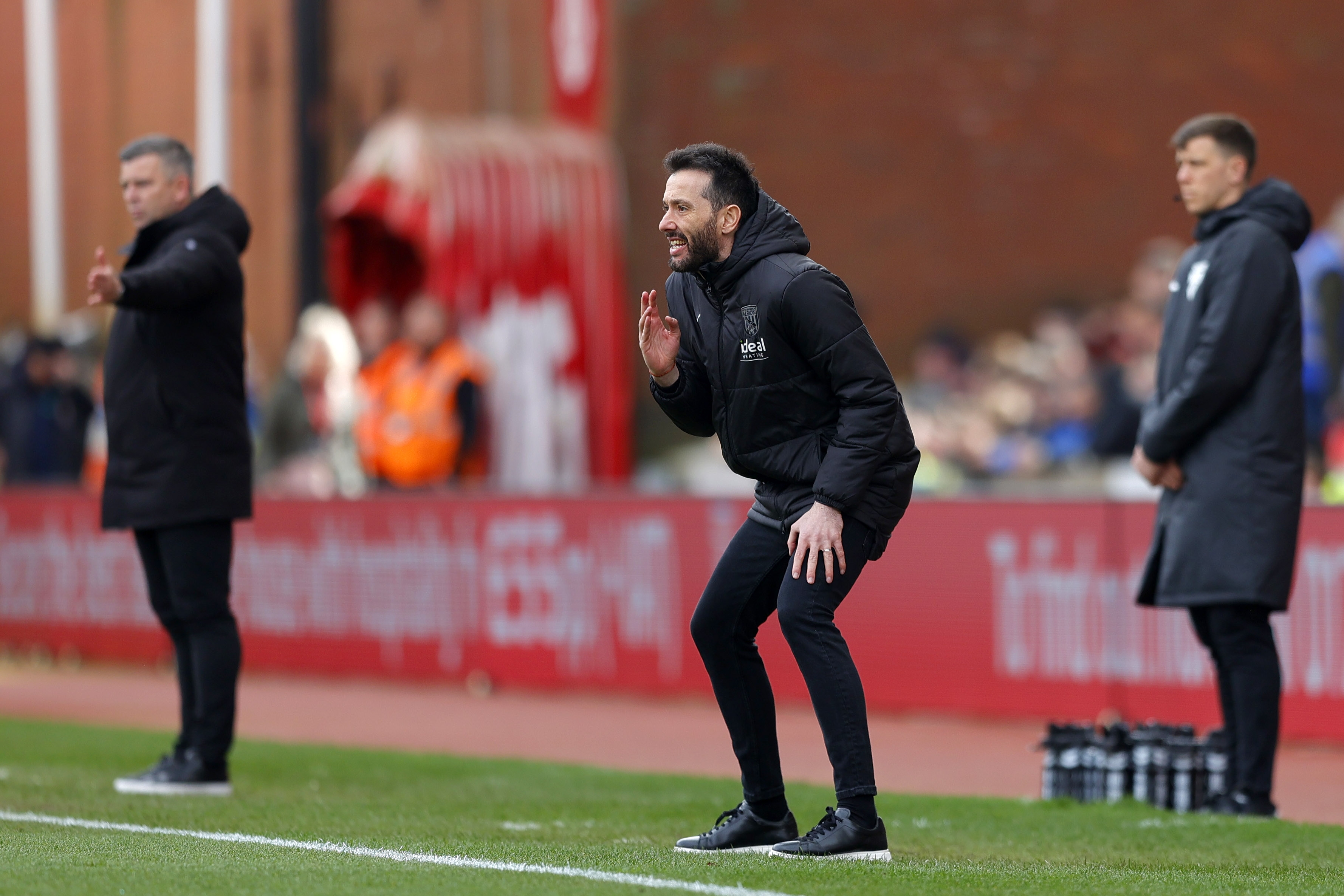 Carlos Corberán delivering information to his players on the side of the pitch against Stoke City