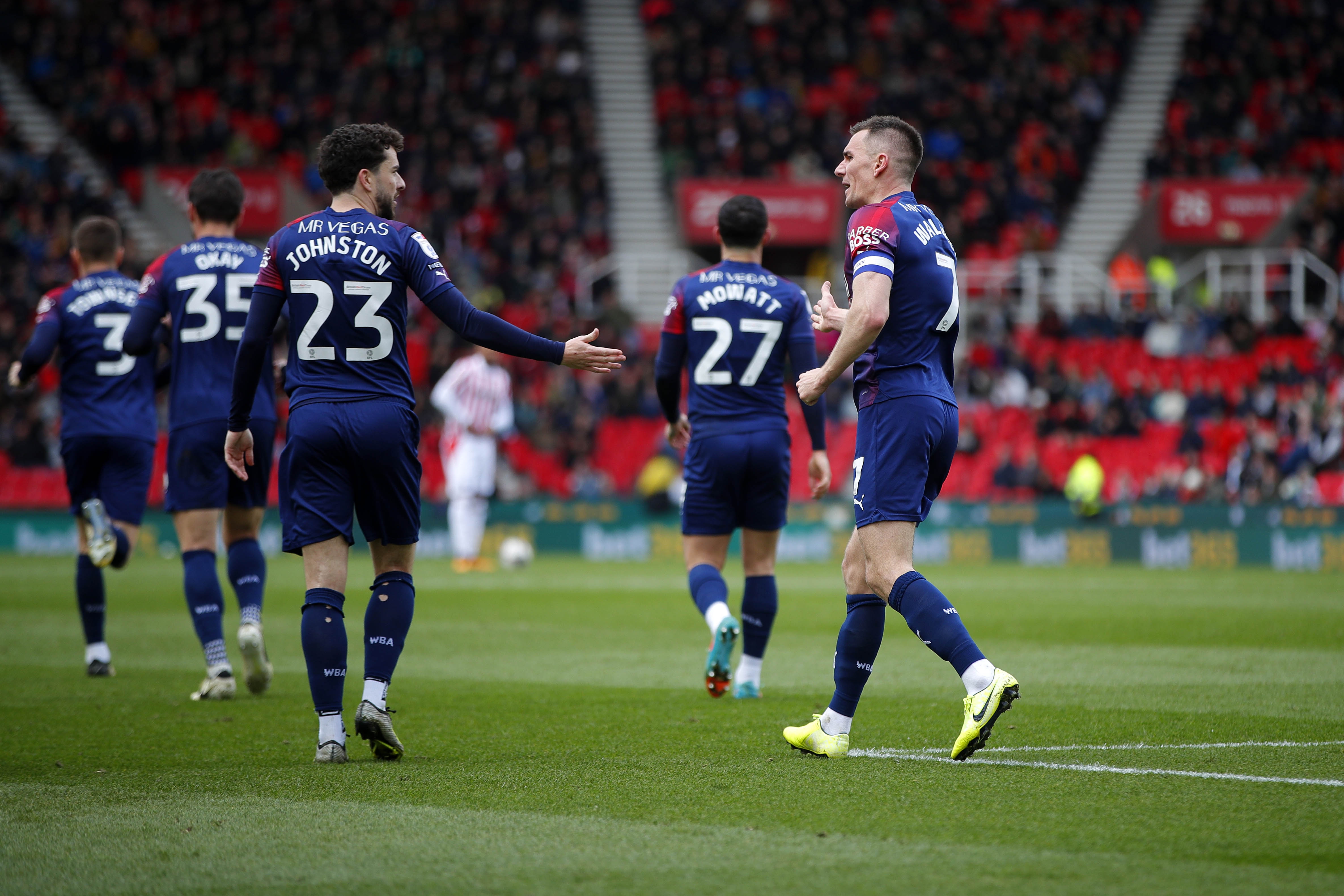 Mikey Johnston and Jed Wallace celebrate the latter's goal at Stoke City while wearing the navy blue and red away kit