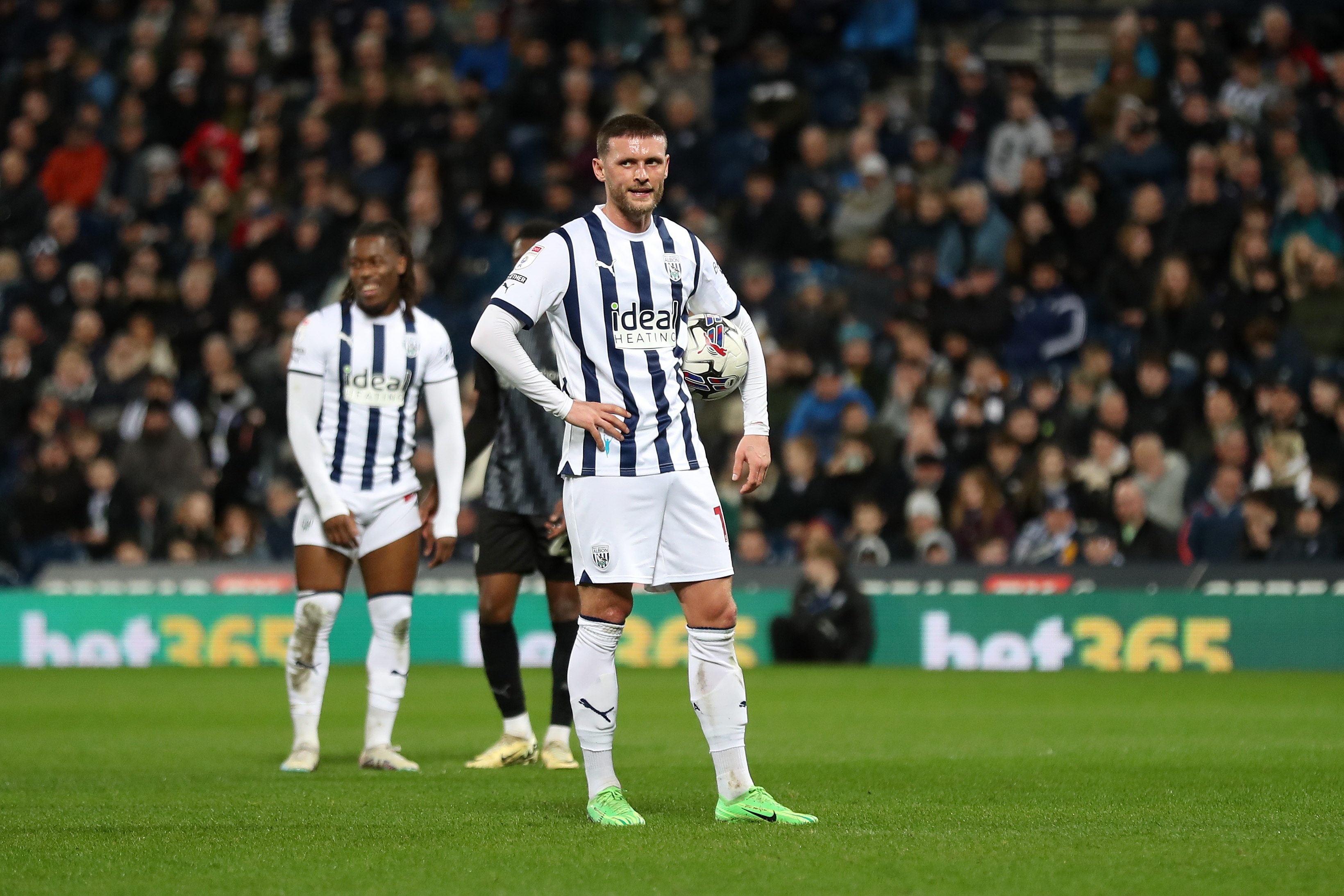 John Swift holding the ball preparing to take a penalty against Rotherham United at The Hawthorns