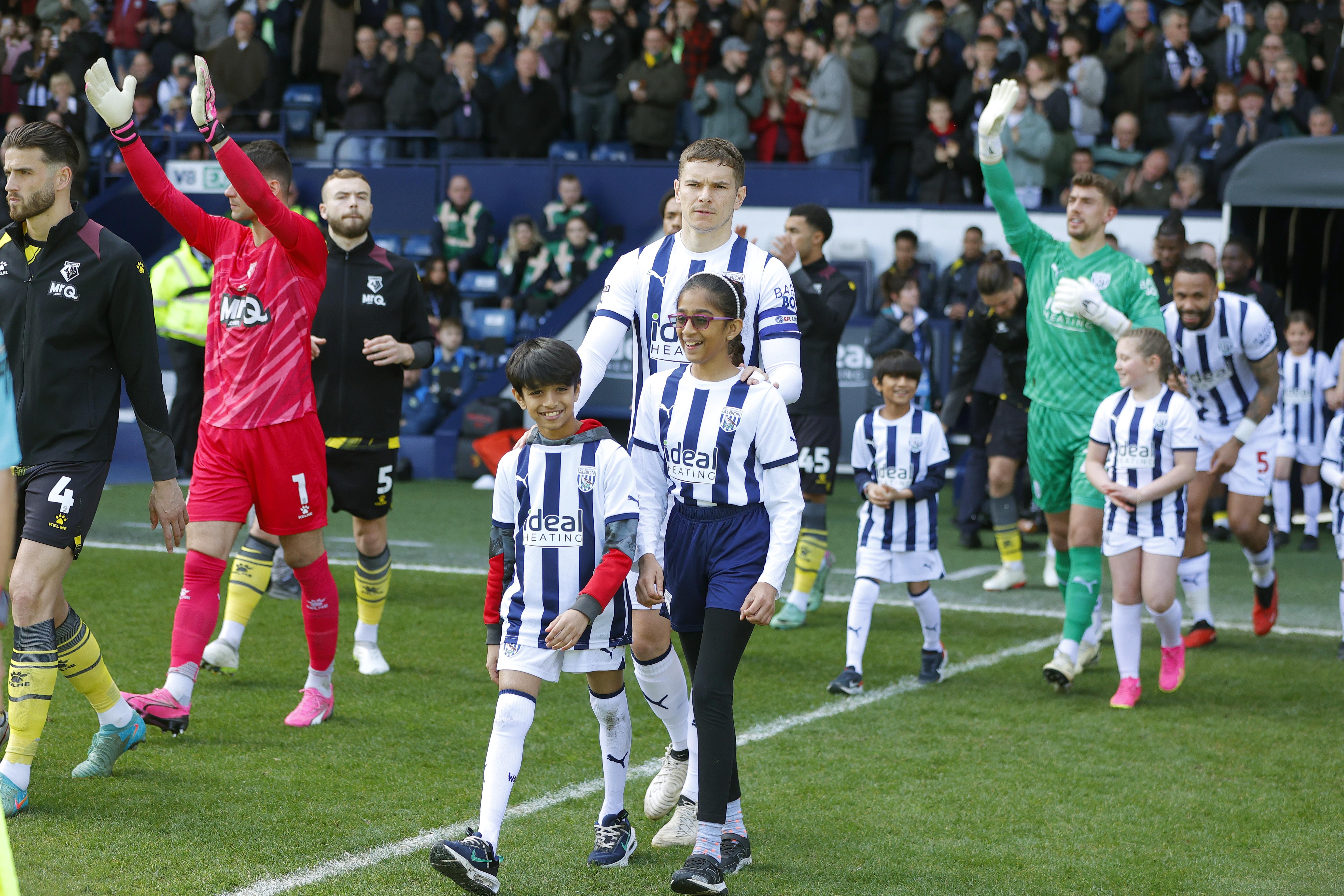 Conor Townsend leads Albion out at The Hawthorns against Watford with two mascots
