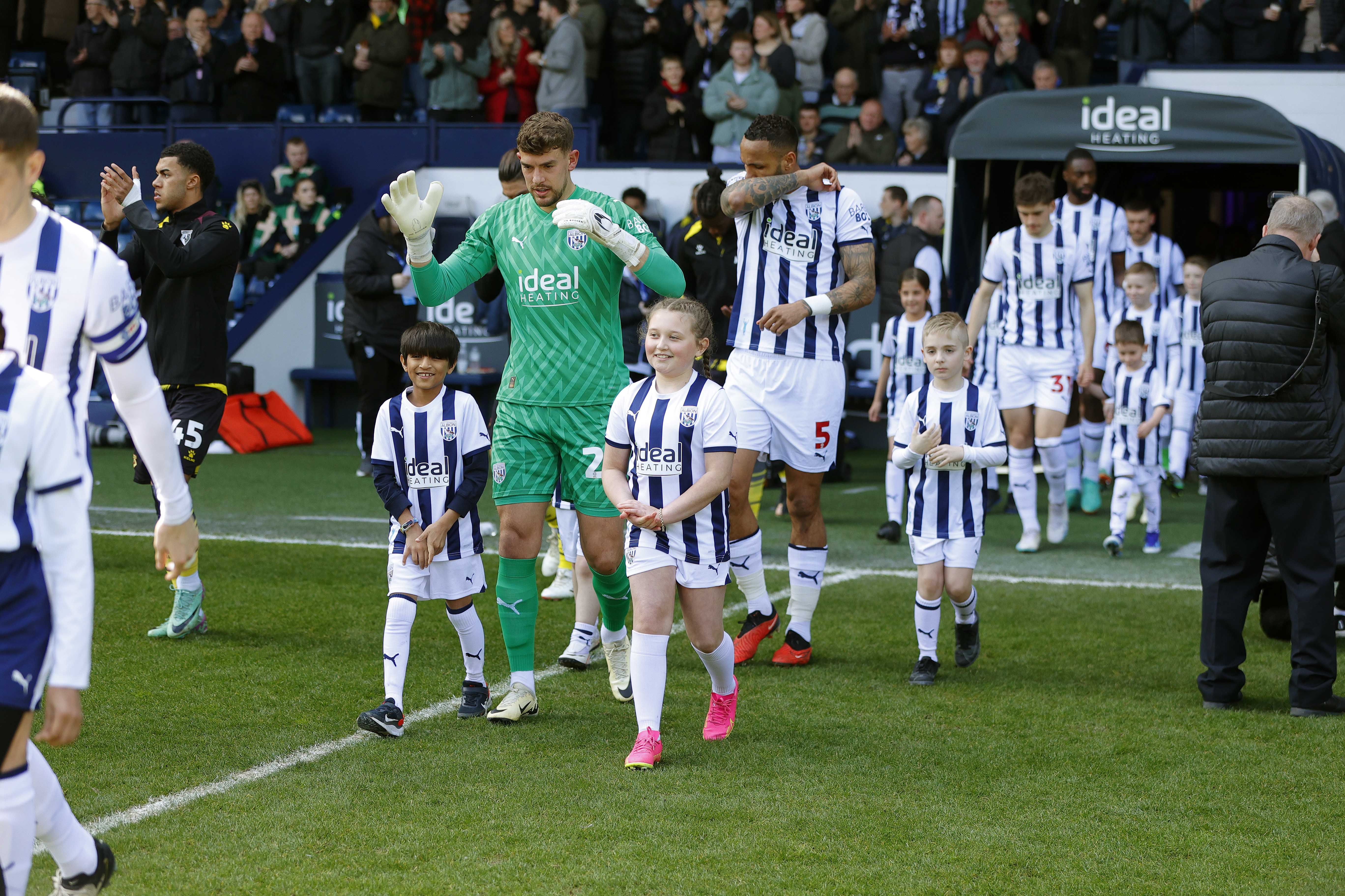 Alex Palmer walking out of the tunnel at The Hawthorns against Watford with two mascots