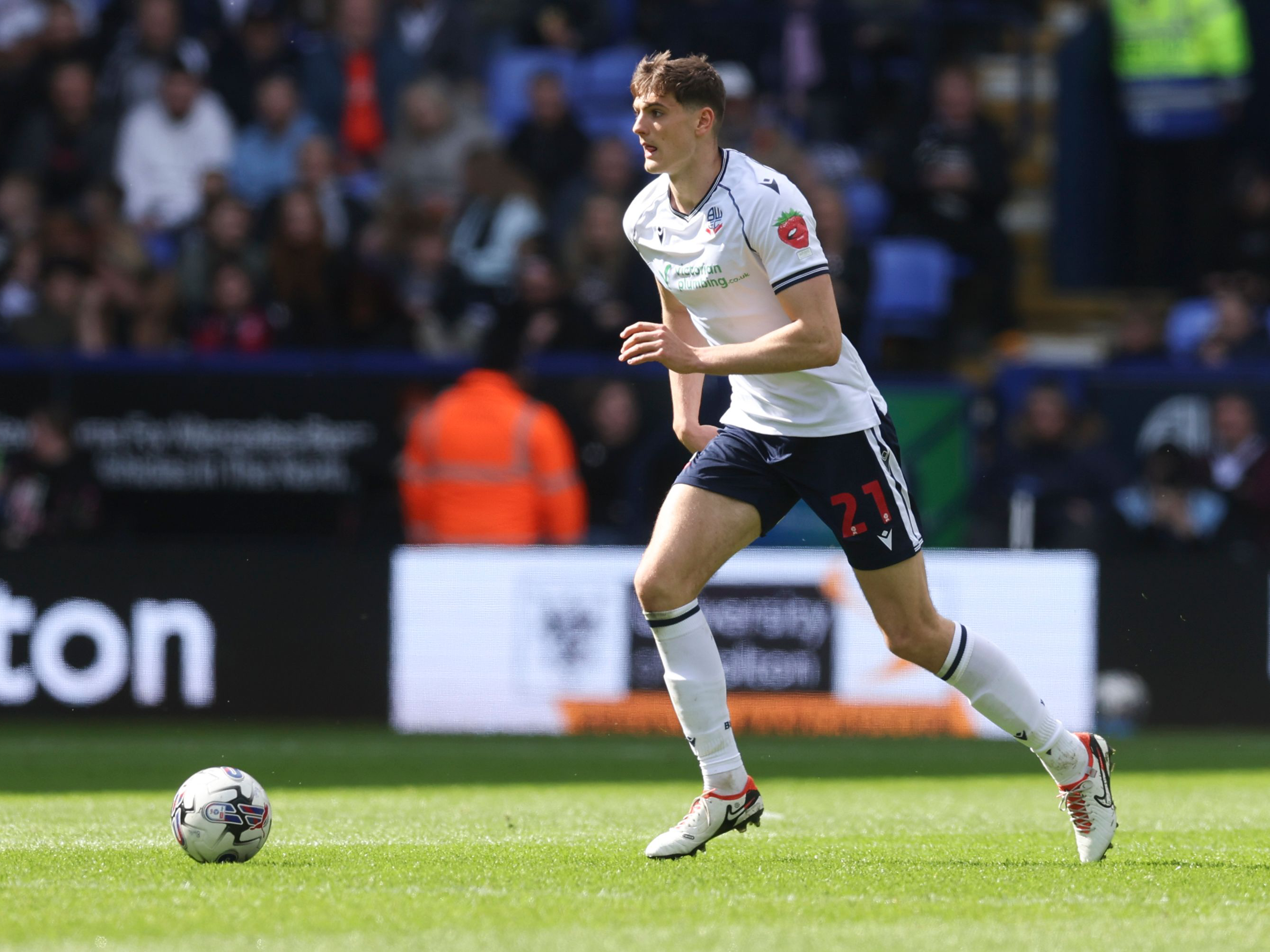 A photo of Caleb Taylor in action for loan club Bolton Wanderers in their 23/24 white home kit