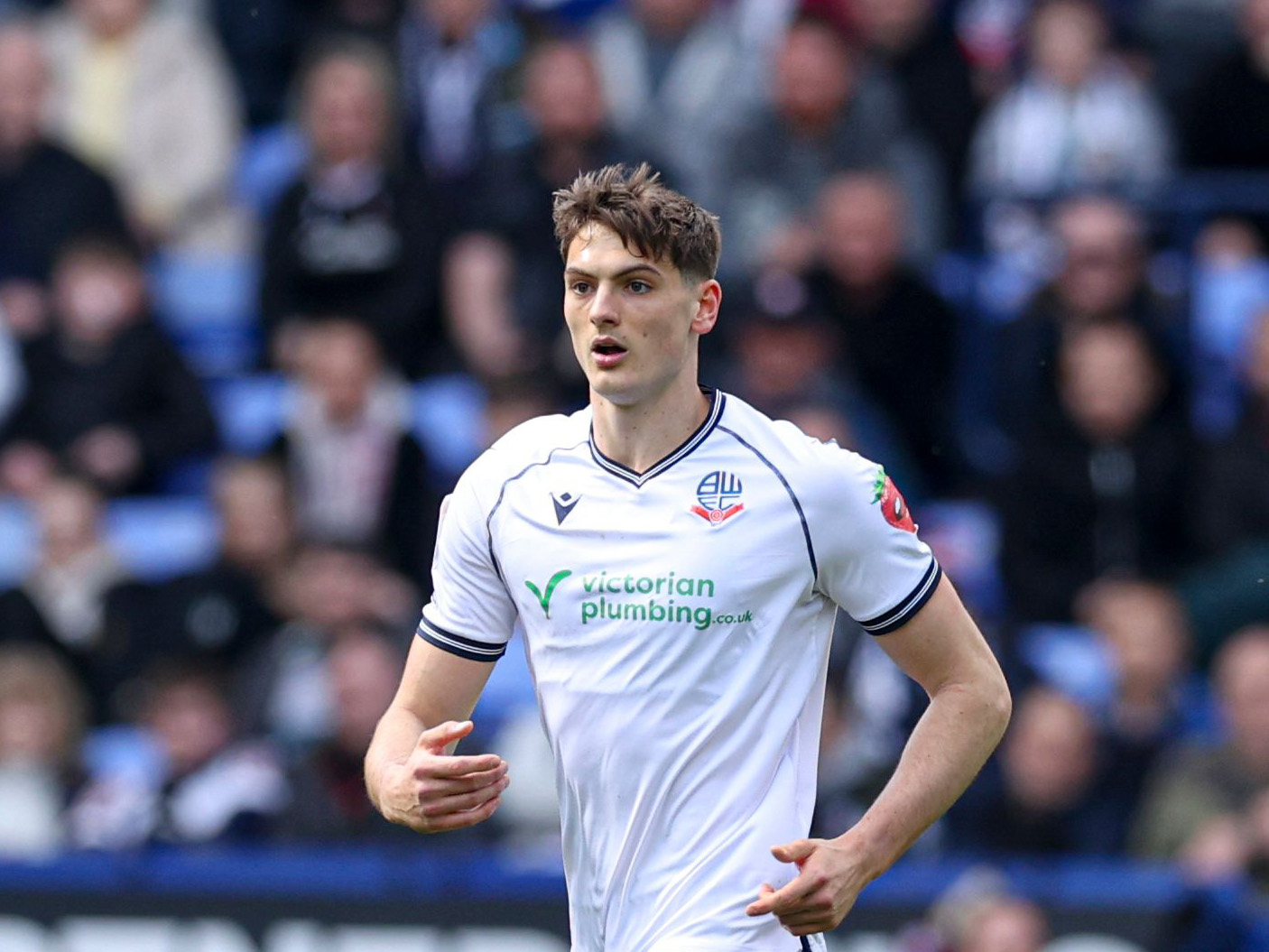 Caleb Taylor playing for Bolton while wearing their home kit