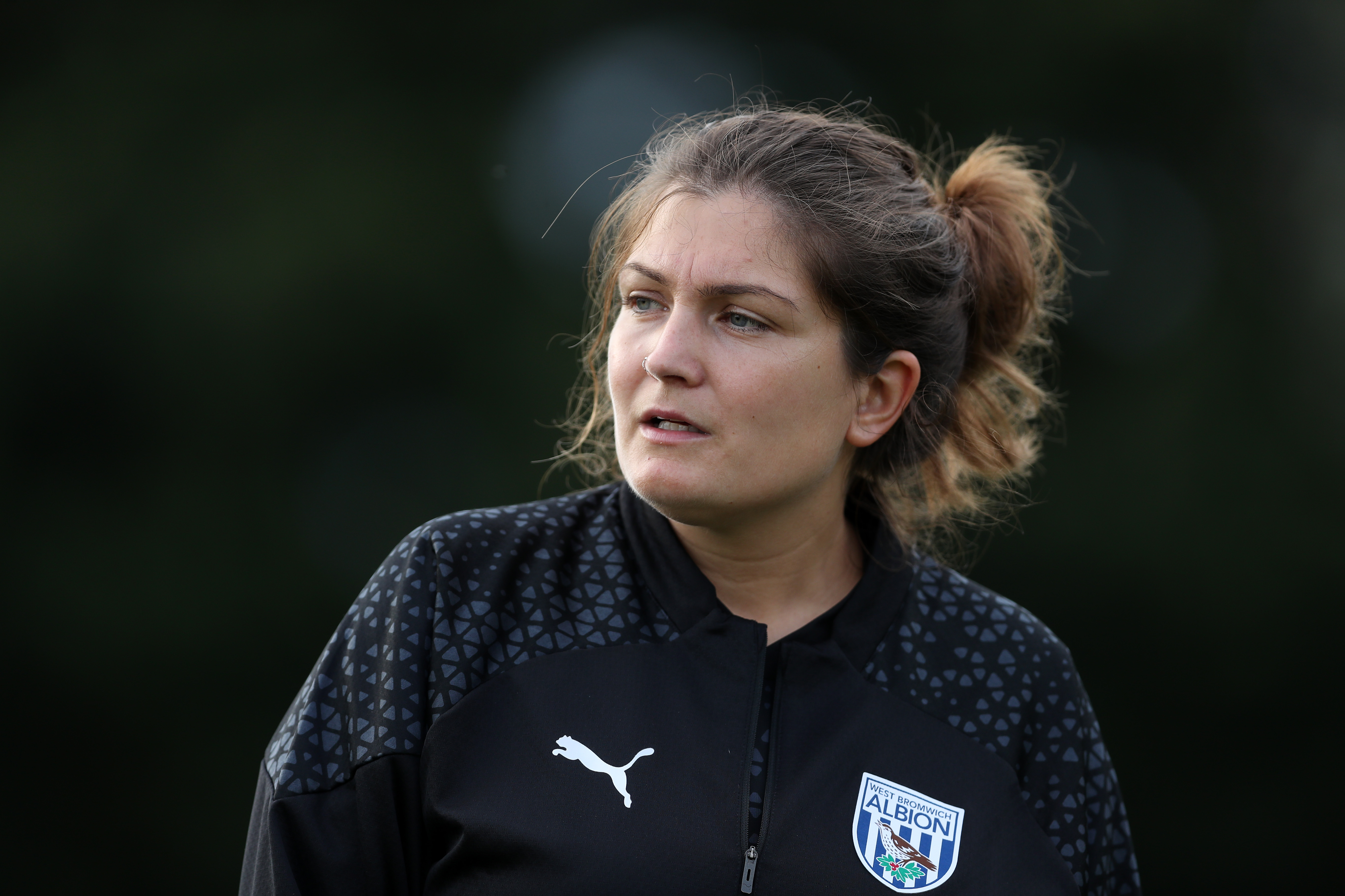Siobhan Hodgetts-Still watching a training session while wearing black Albion training gear