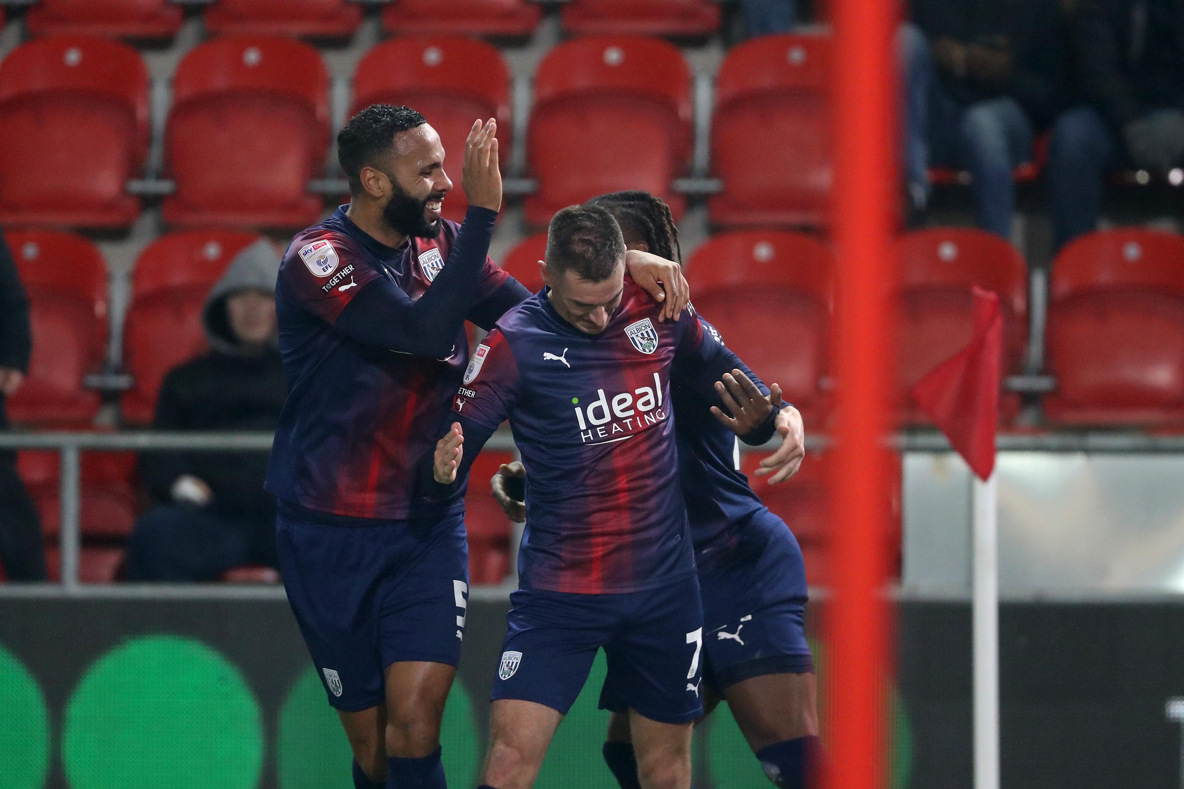 Jed Wallace celebrates scoring against Rotherham in the navy blue and red kit with Kyle Bartley