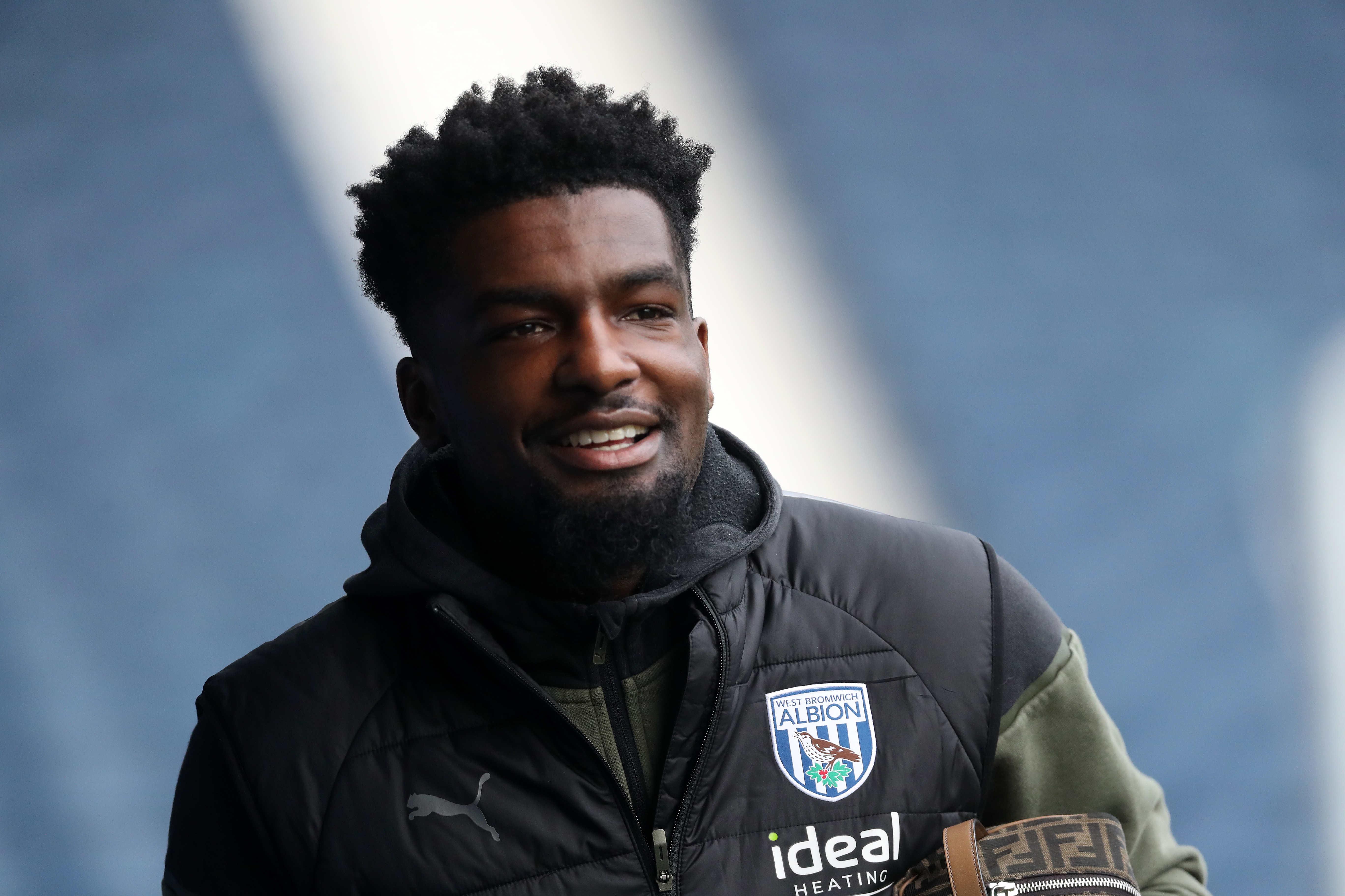 Cedric Kipre smiling while wearing an Albion tracksuit 