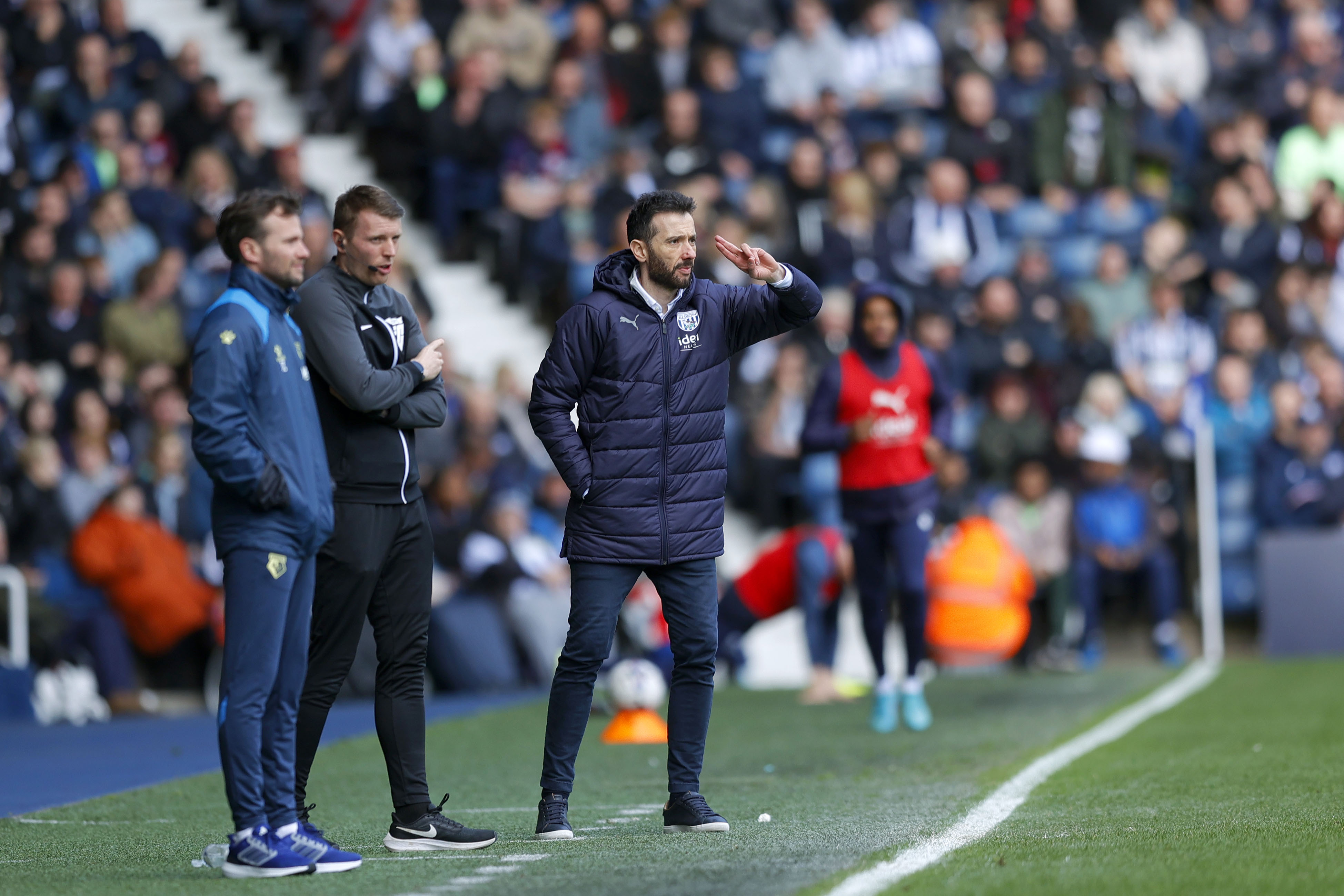 Carlos Corberán delivering instructions to his players on the side of the pitch at The Hawthorns