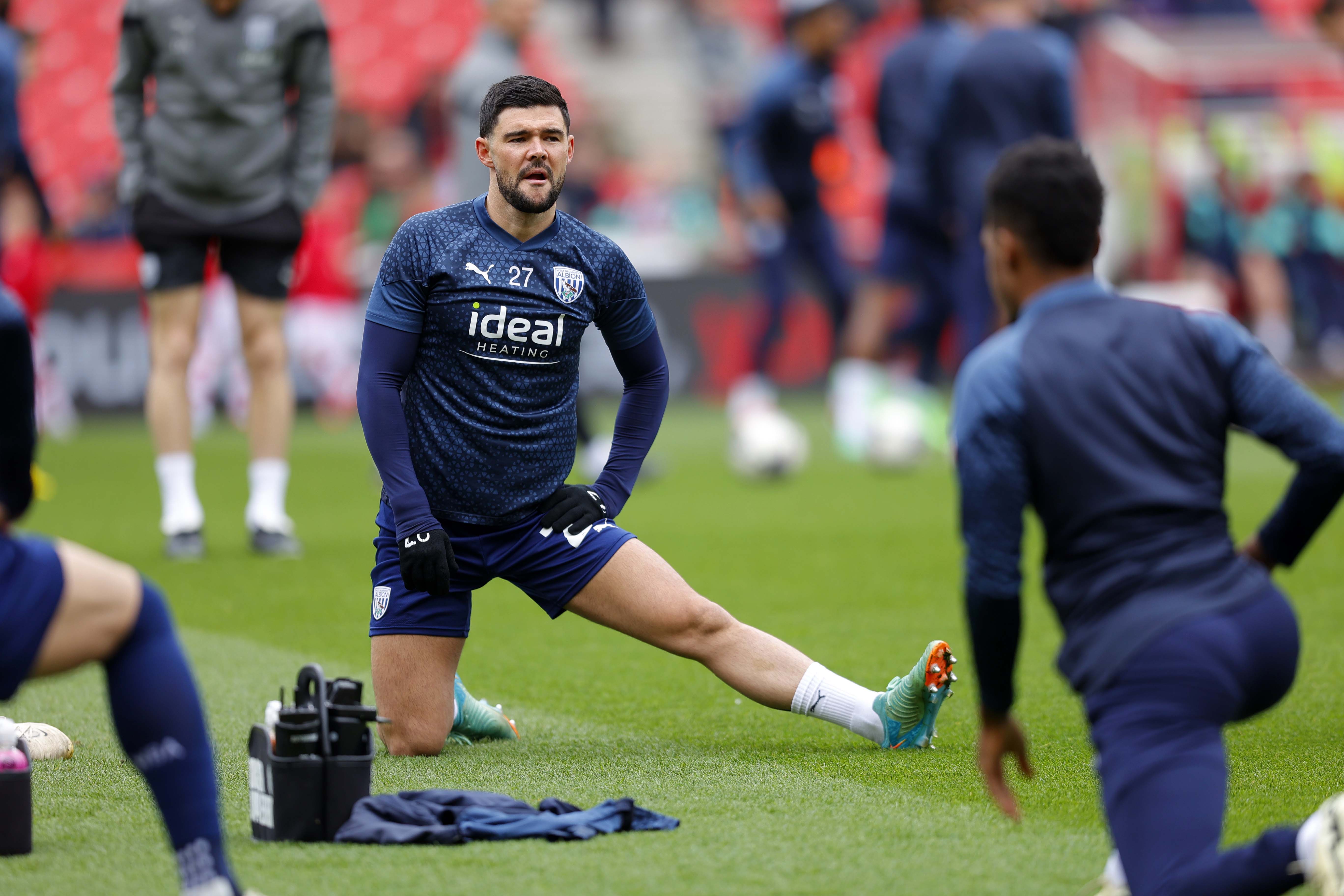 Alex Mowatt stretching during a warm up before a game
