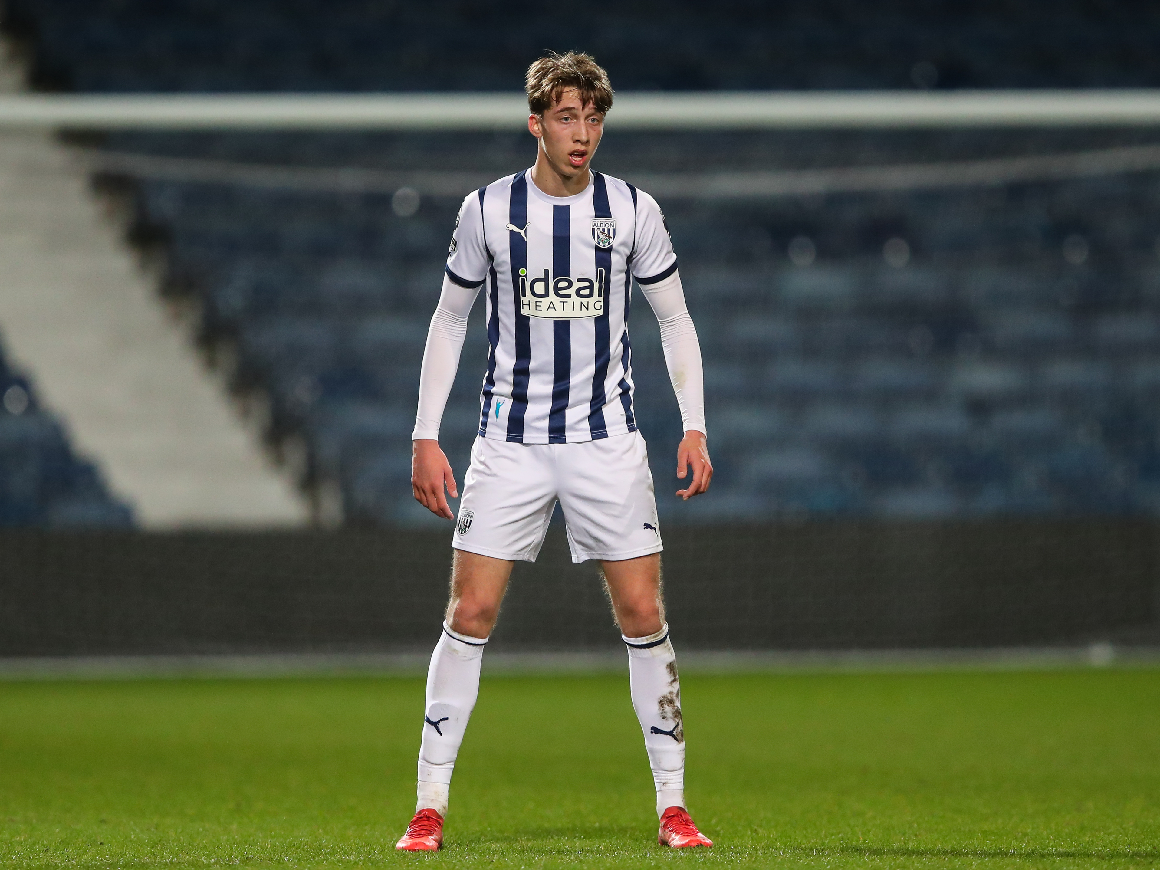 A photo of Harry Whitwell, in the 23/24 home kit, in action for Albion's PL2 team at The Hawthorns