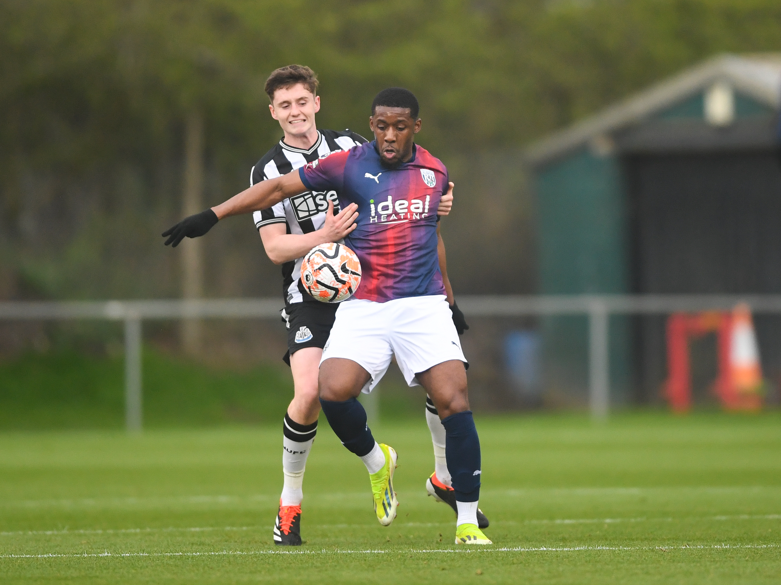 A photo of Jovan Malcolm in the red and blue 23/24 away kit, in action for Albion's PL2 team v Newcastle