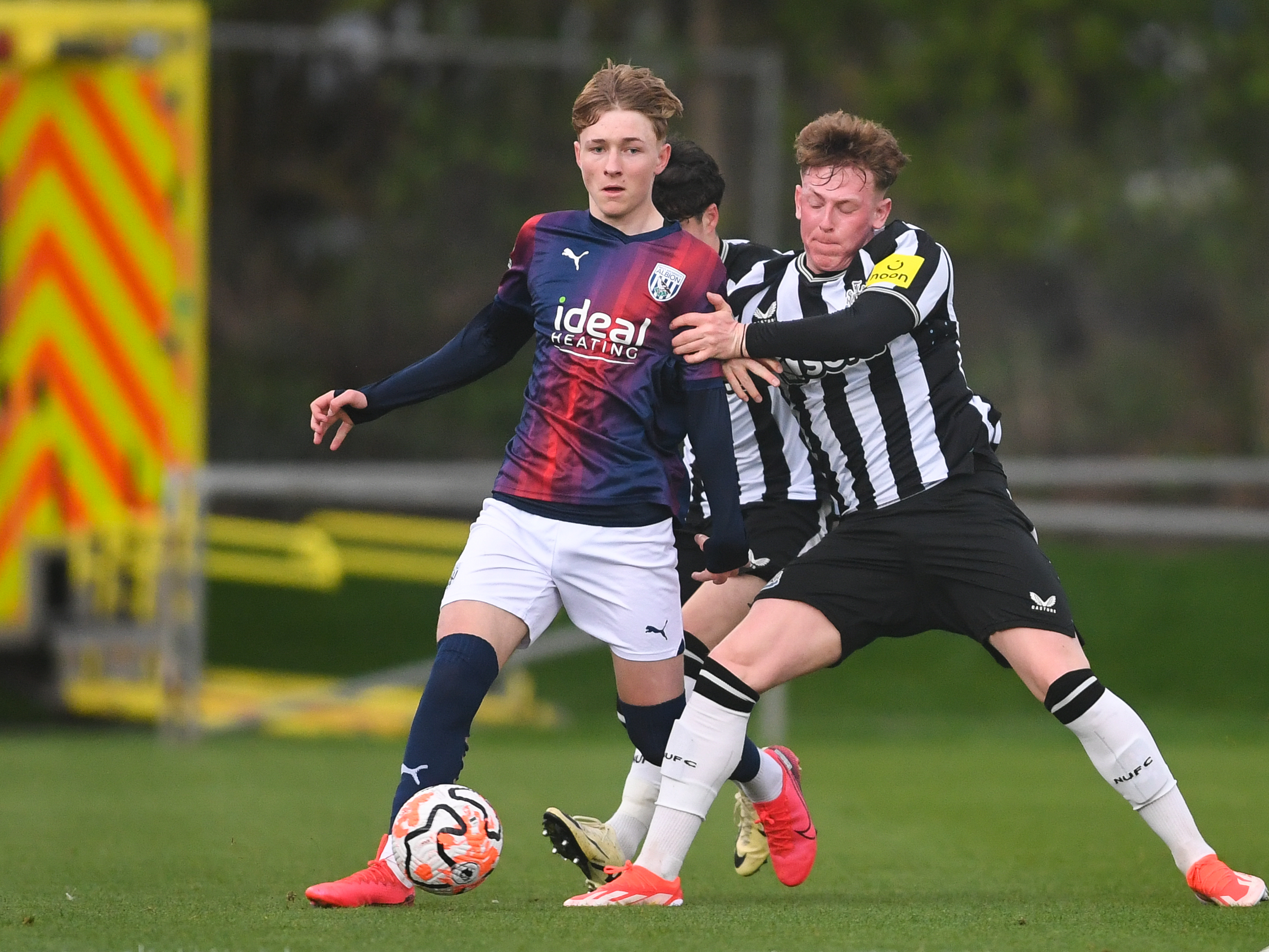 A photo of Ollie Bostock in the red and blue 23 24 kit in action for Albion's PL2 team v Newcastle