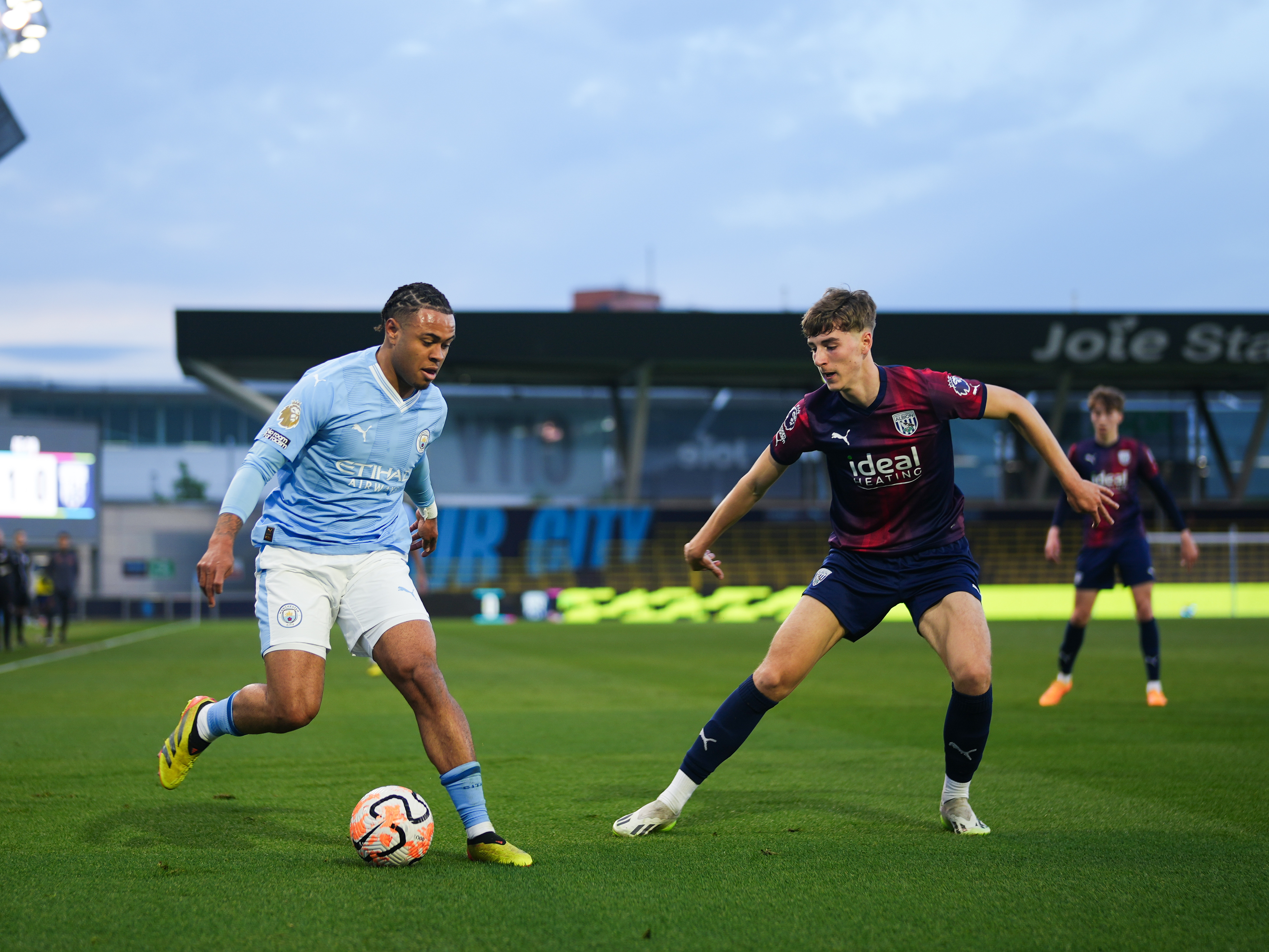 A photo of Josh Shaw, in the red and blue 23/24 away kit, in action in the PL2 v Man City