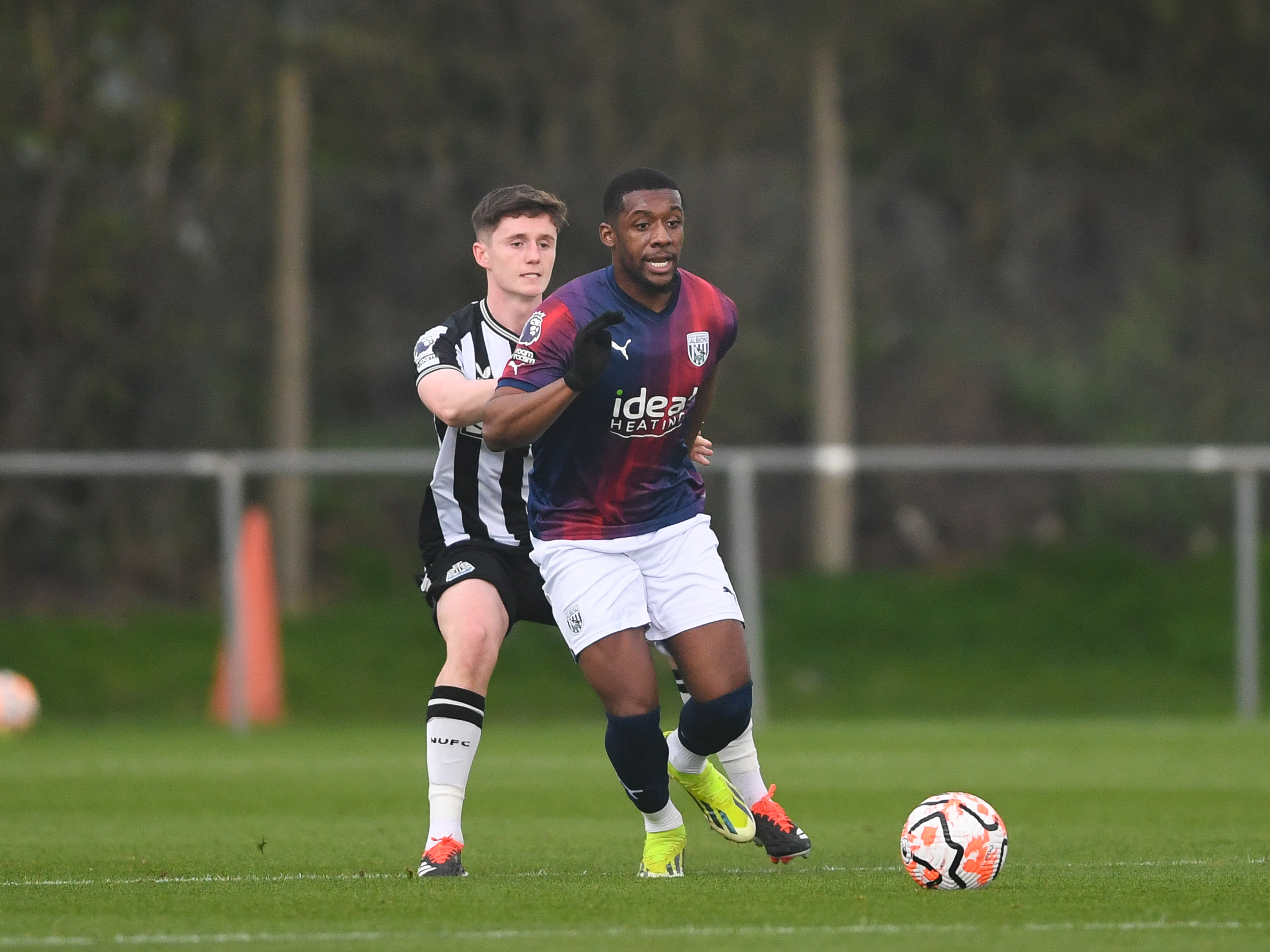 A photo of Jovan Malcolm, in the 23/24 red and blue kit, in action for Albion's PL2 team v Newcastle