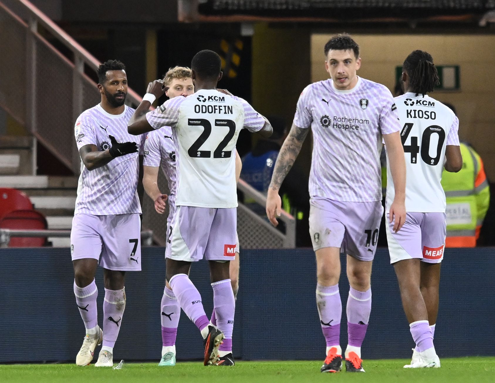 Rotherham United players celebrate scoring a goal in their away kit