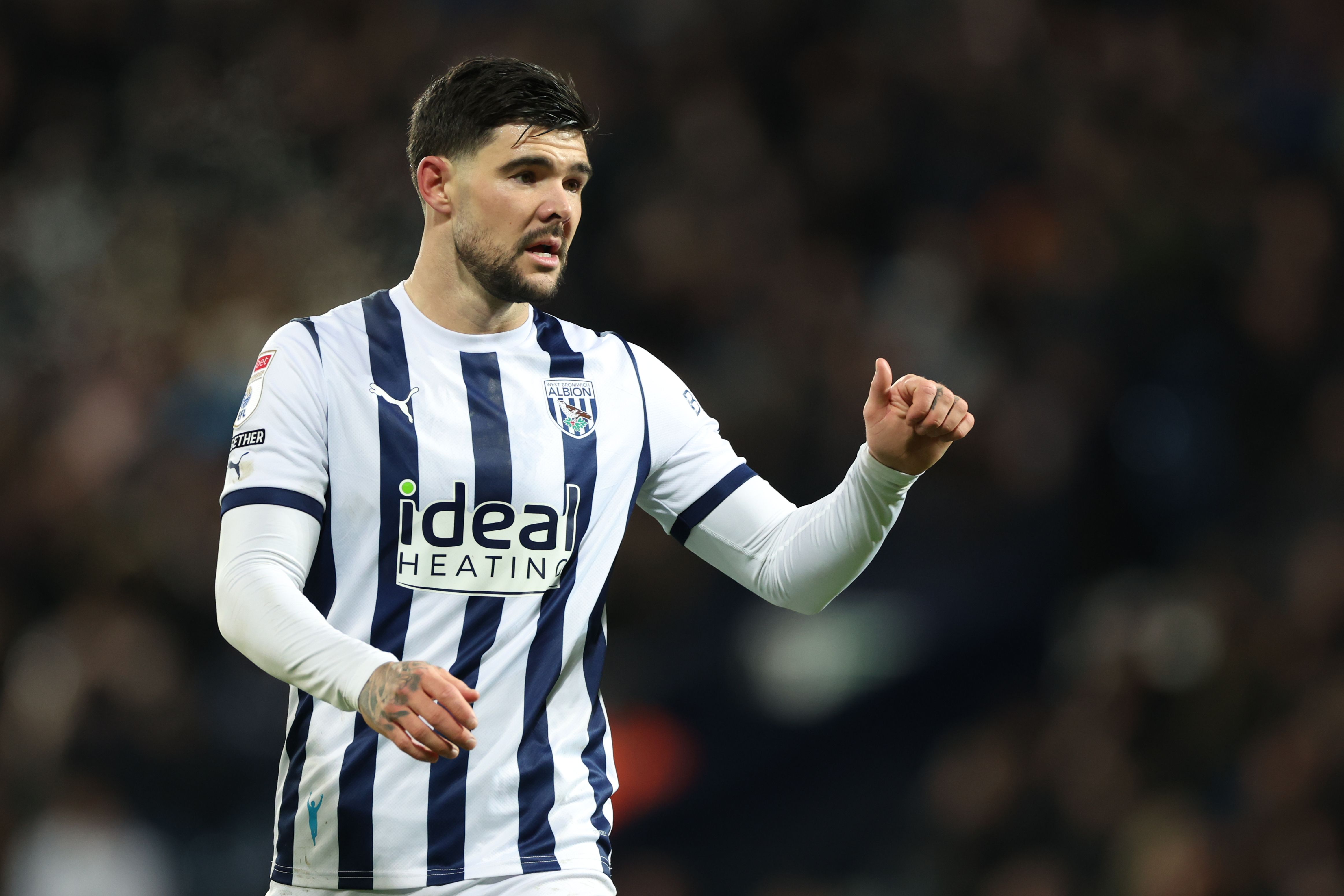 Alex Mowatt with his thumb up during an Albion game wearing the home kit 