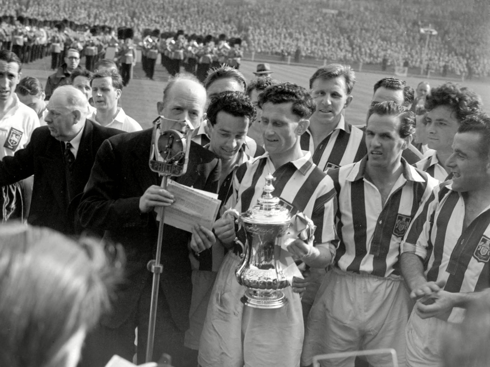 Albion players with the FA Cup trophy down on the pitch at Wembley 