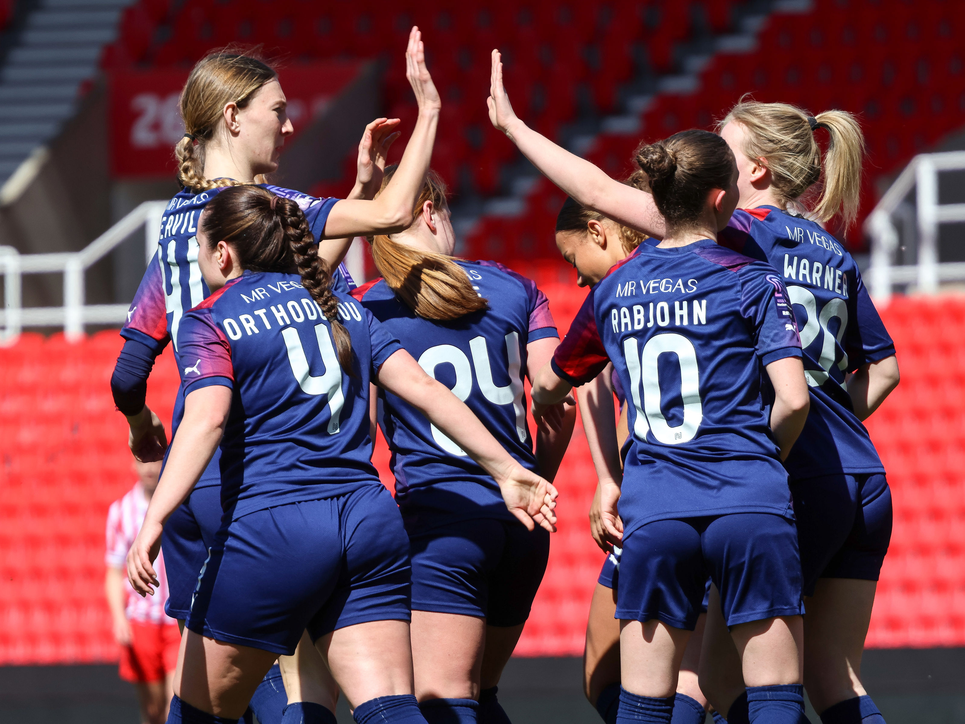 An image of the whole Albion Women team celebrating a goal against Stoke City