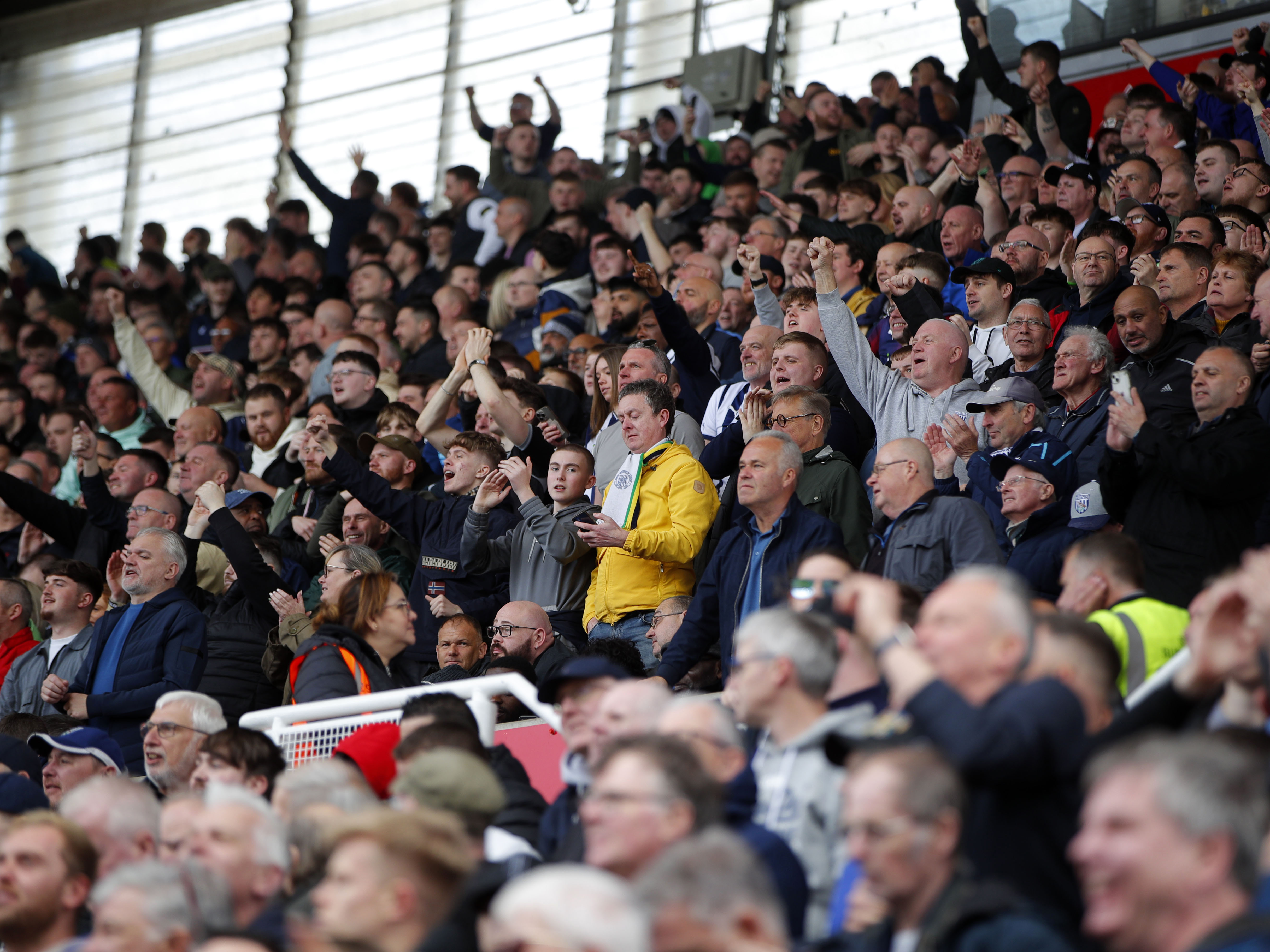 A general view of WBA fans cheering on their side at Stoke