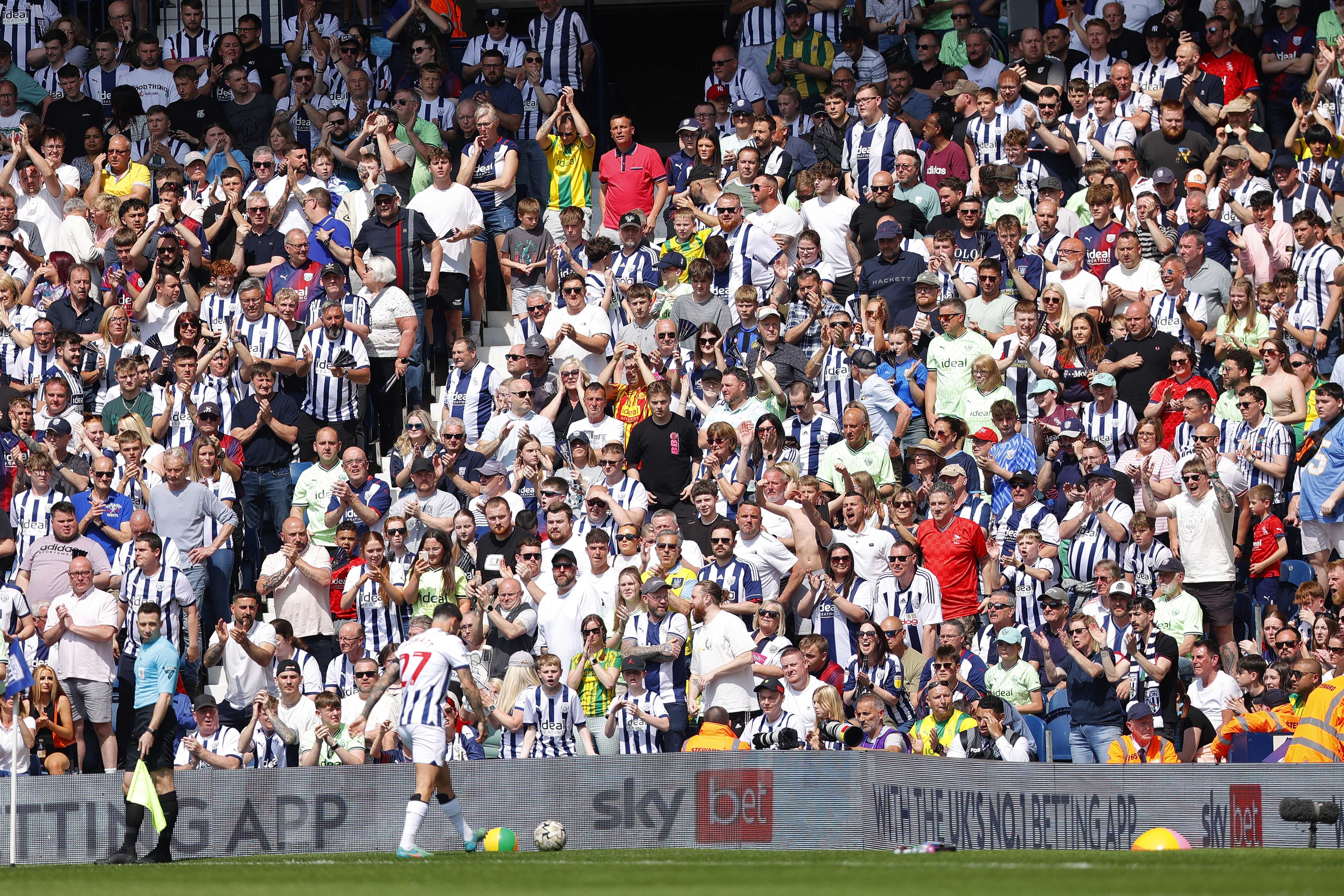 Alex Mowatt prepares to take a corner against Southampton at The Hawthorns with several Albion fans behind him