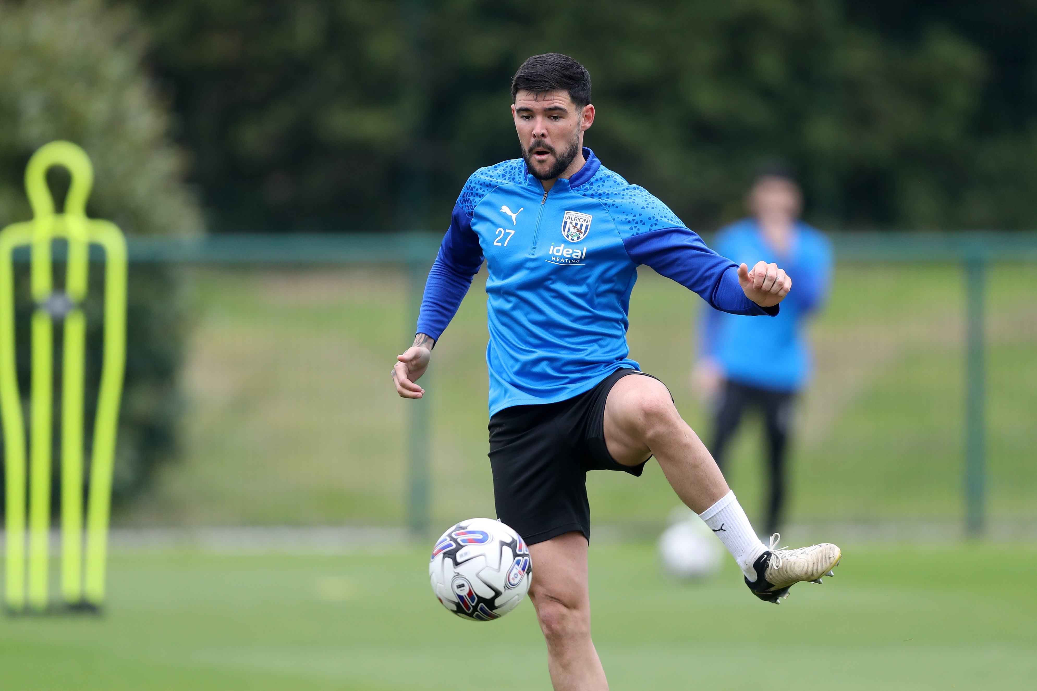 Alex Mowatt passing the ball during a training session