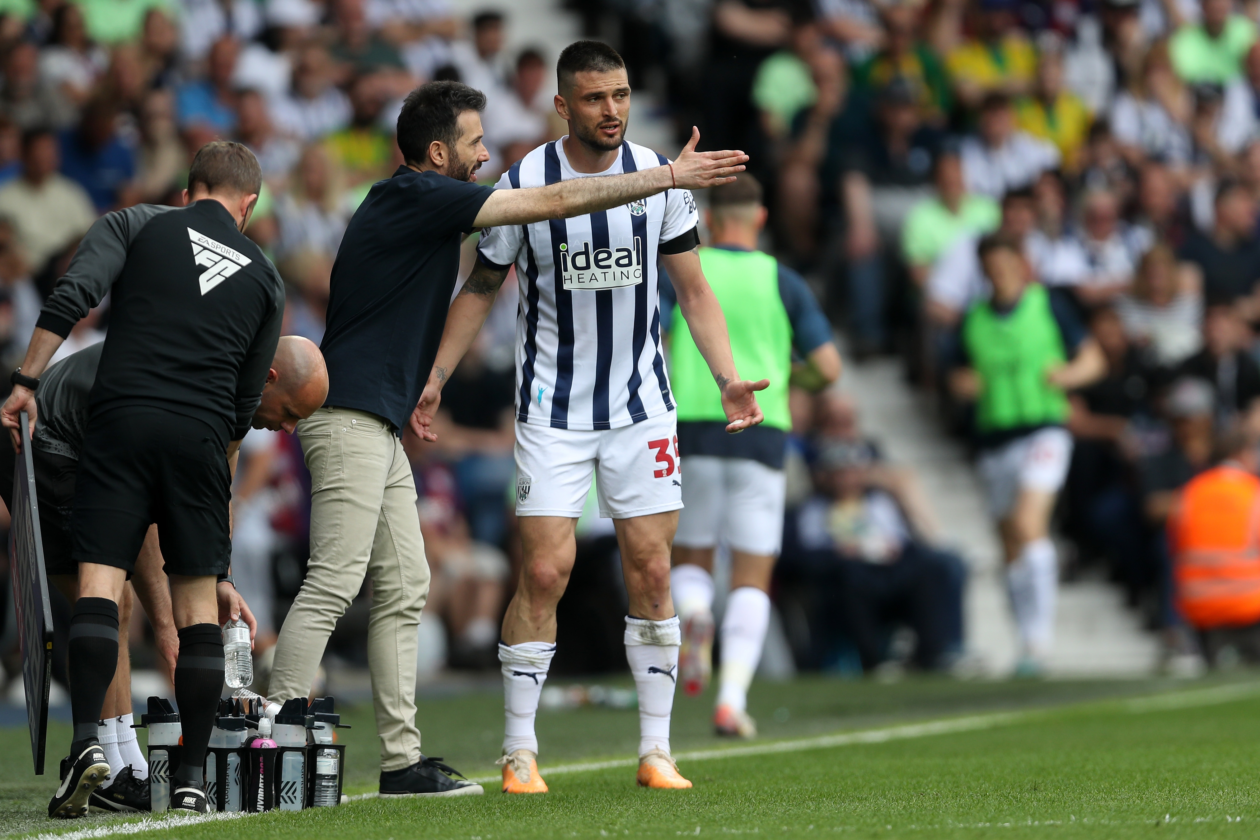 Carlos Corberán delivering a message to Okay Yokuslu on the side of the pitch at The Hawthorns against Southampton 