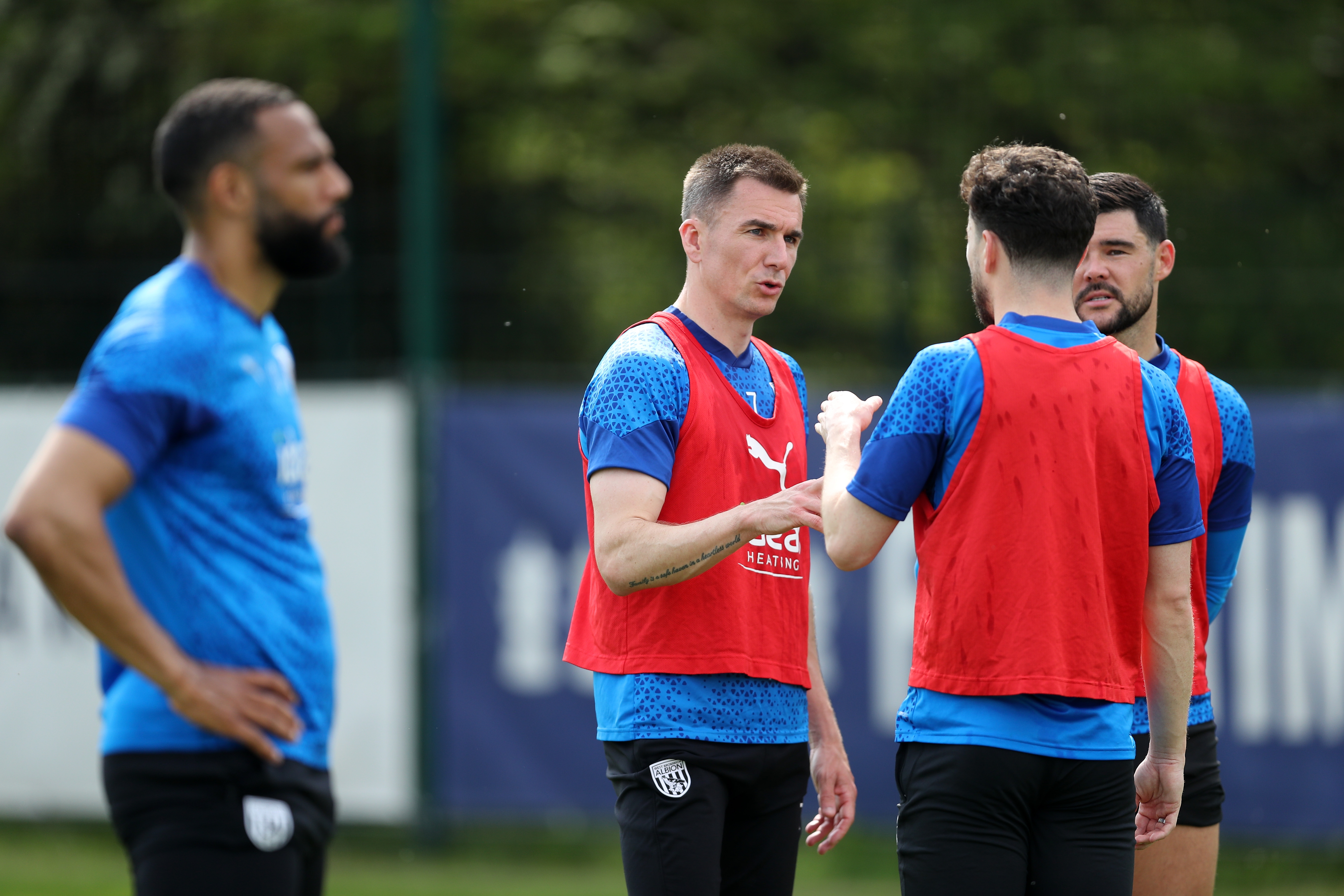 Jed Wallace talking to Mikey Johnston and Alex Mowatt during training 