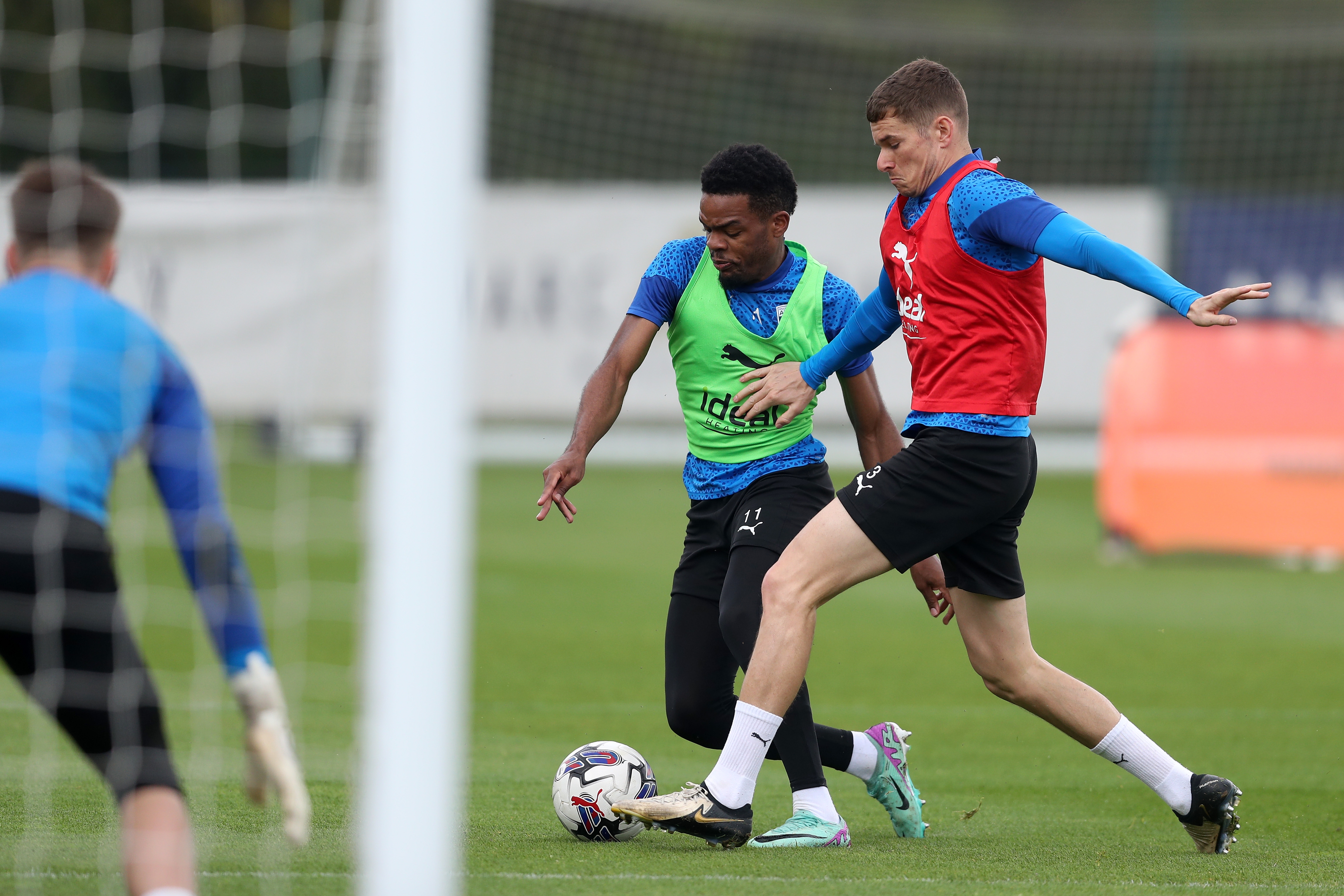 Grady Diangana and Conor Townsend fight for the ball during a training session