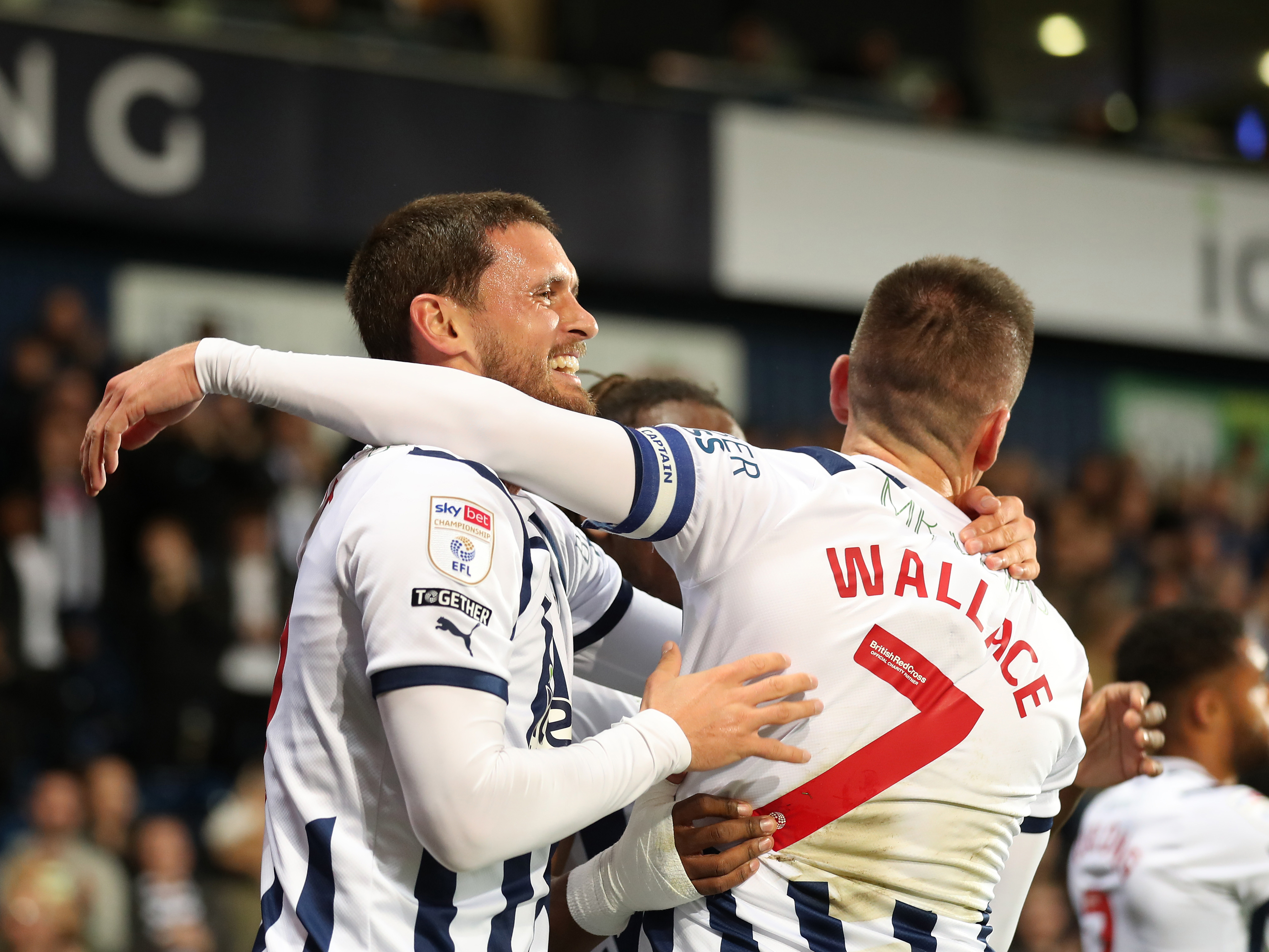 John Swift celebrates scoring a goal for Albion with Jed Wallace while wearing the home kit 