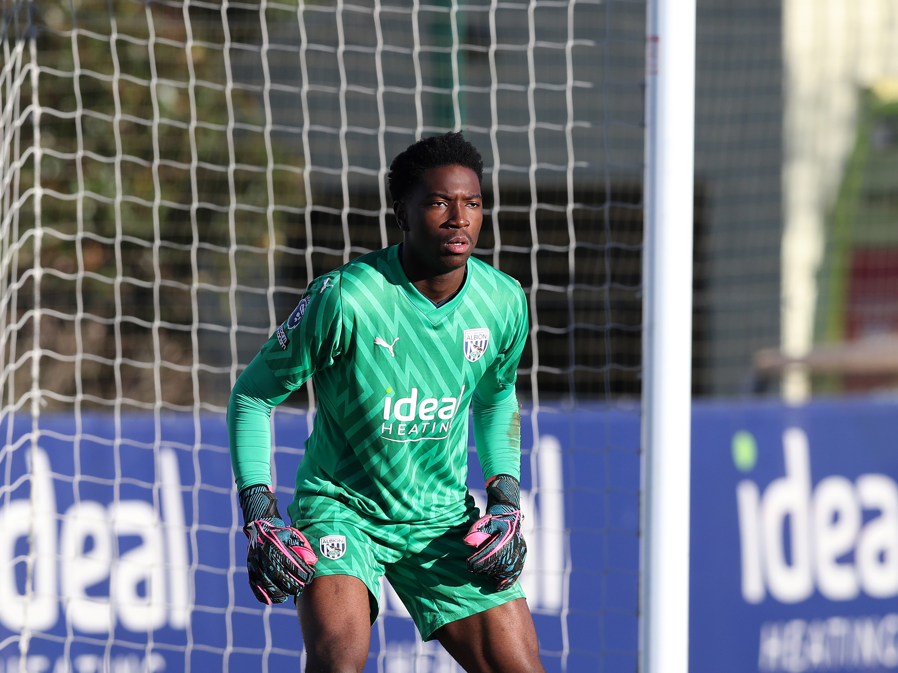 Ben Cisse in action for Albion's PL2 side wearing the green goalkeeper kit 