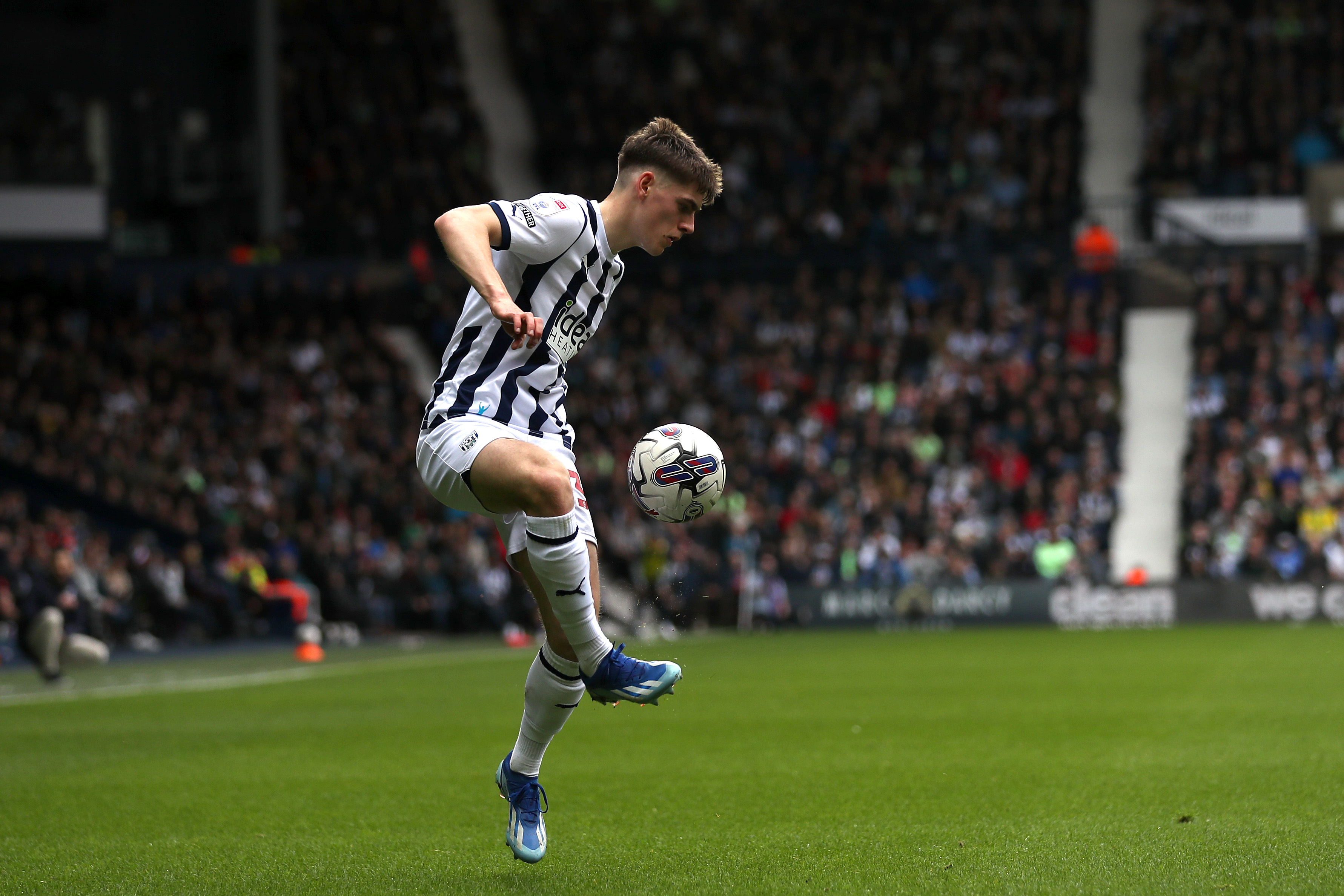 Tom Fellows controlling the ball at The Hawthorns wearing a home Albion kit 