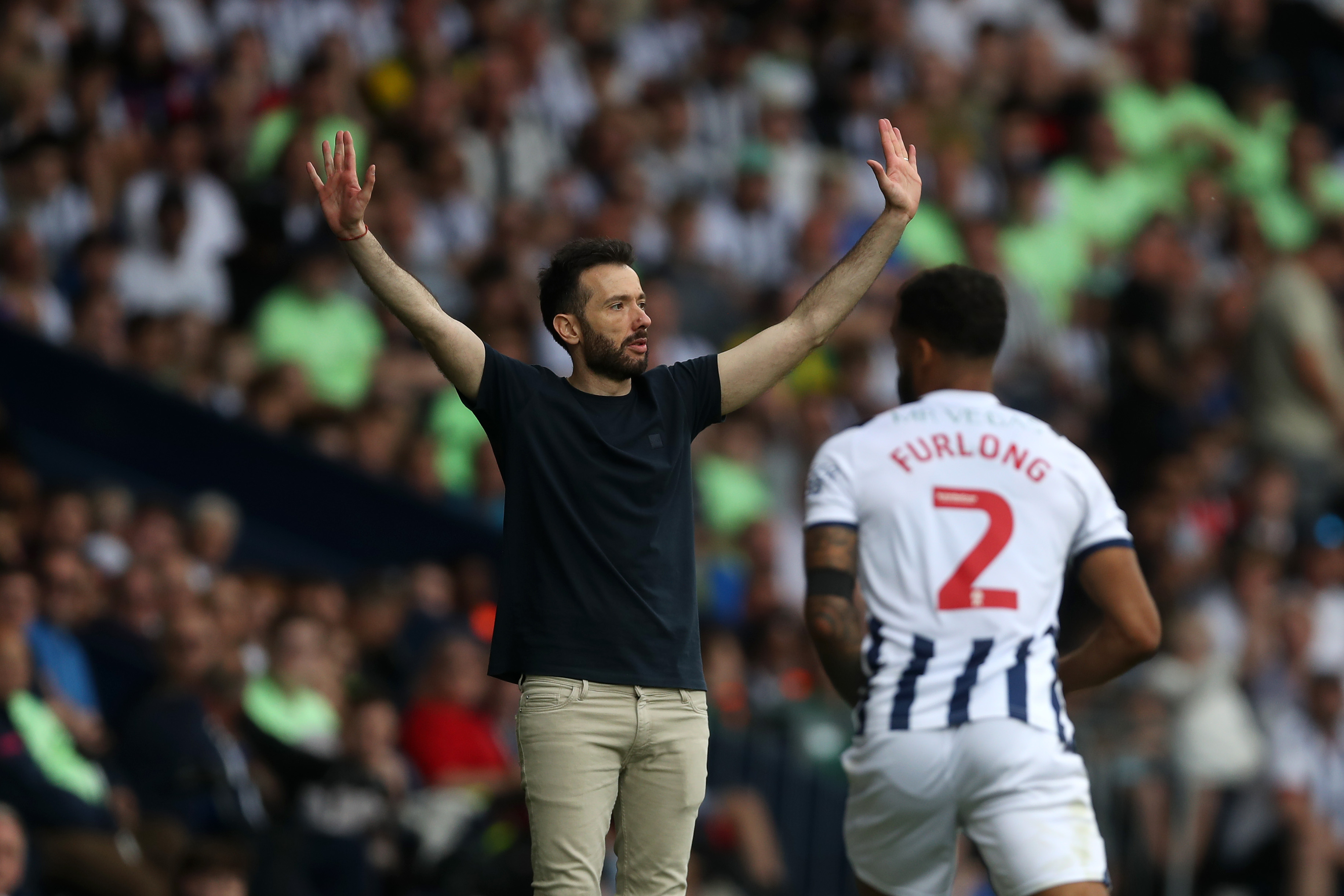 Carlos Corberán with his hands in the air on the touchline during the game against Southampton at The Hawthorns 