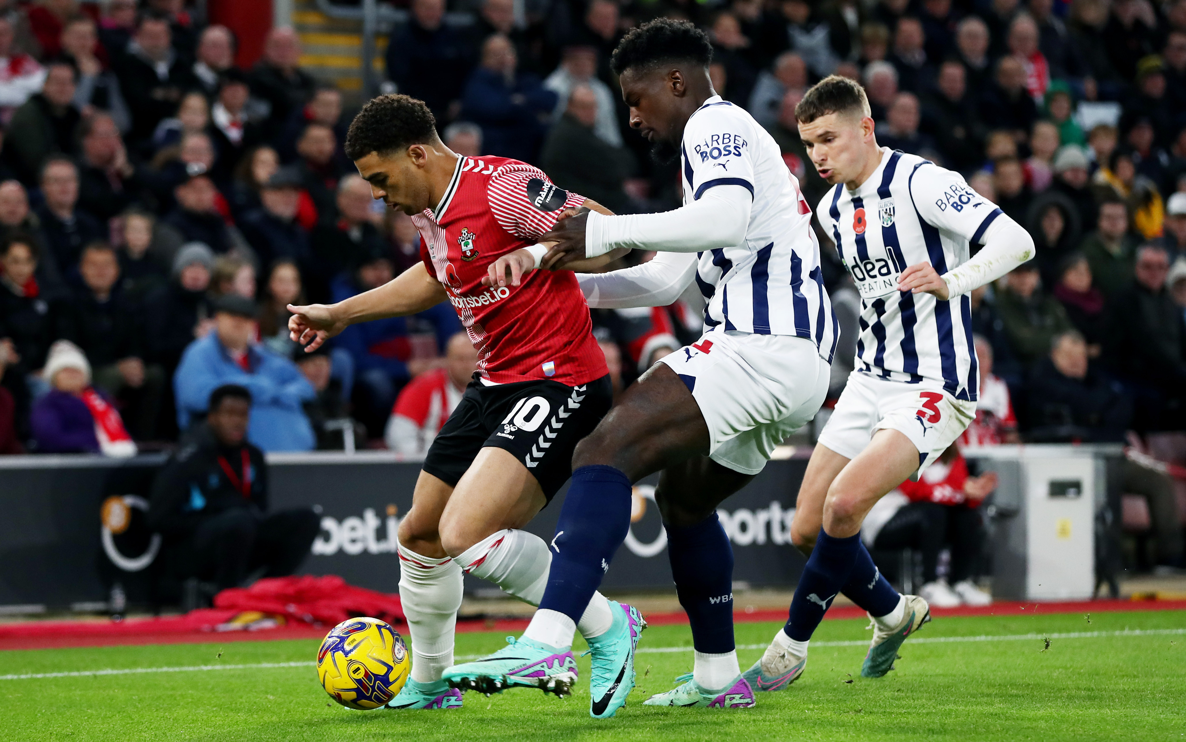 Cedric Kipre and Conor Townsend battle for the ball against Che Adams during Southampton's clash with Albion at St Mary's Stadium