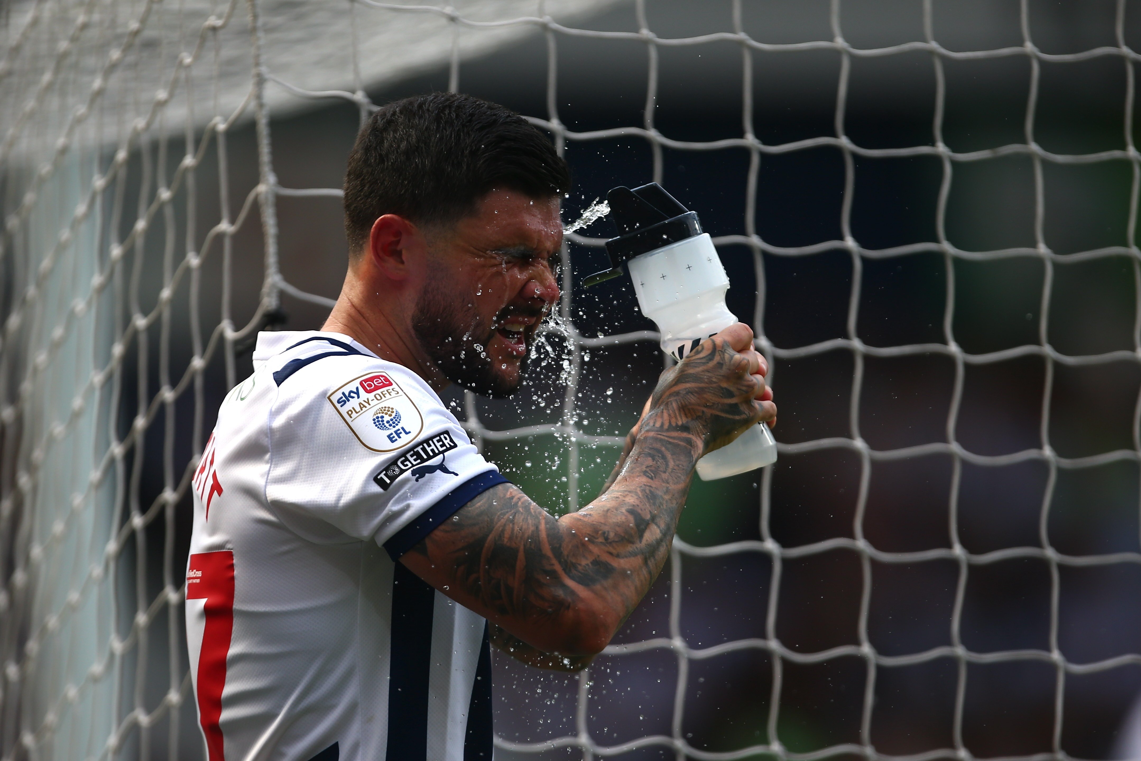Alex Mowatt squirts water in his face at The Hawthorns against Southampton 