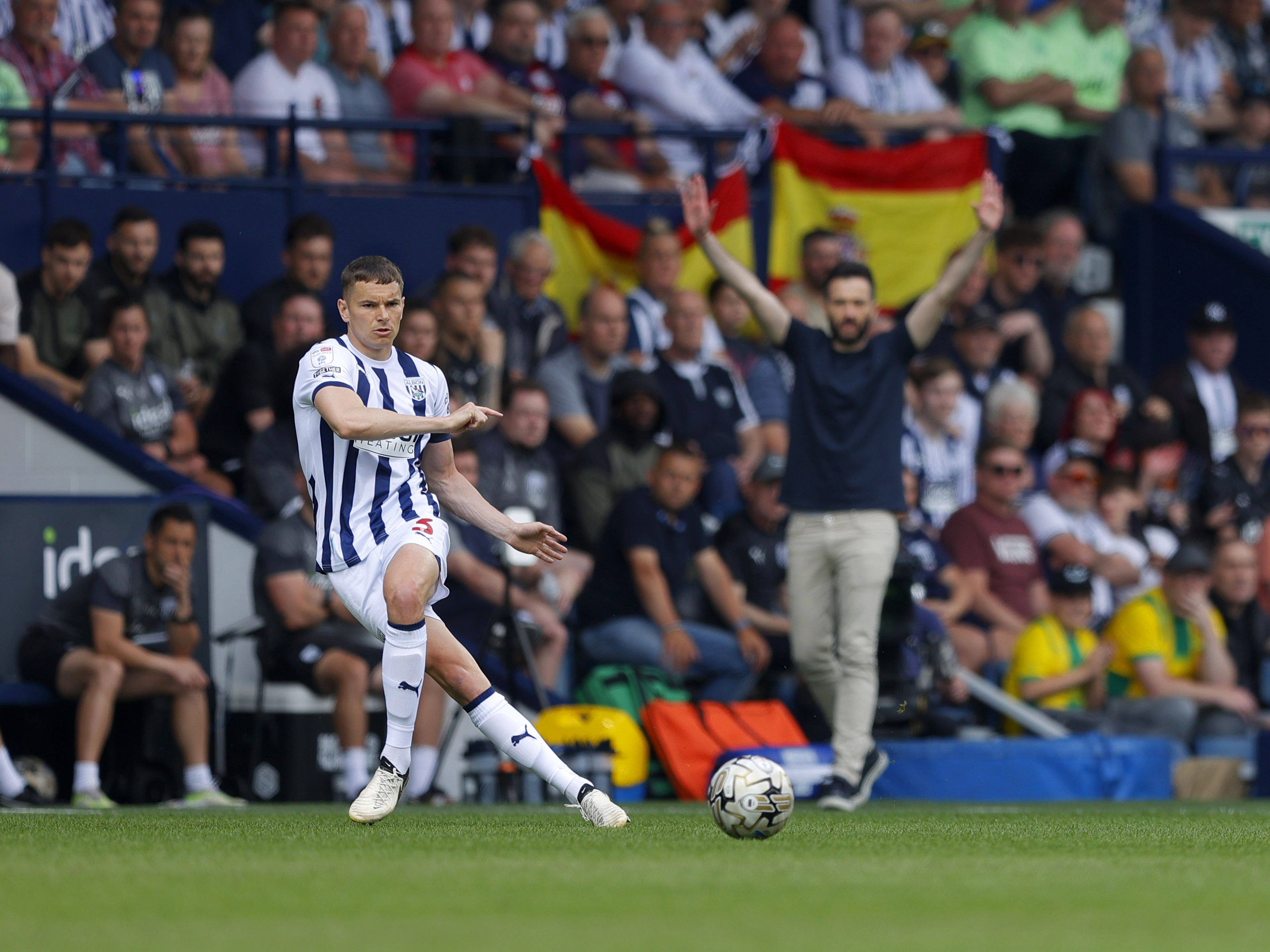 An image of Conor Townsend passing the ball against Southampton, with Carlos Corberan in the background
