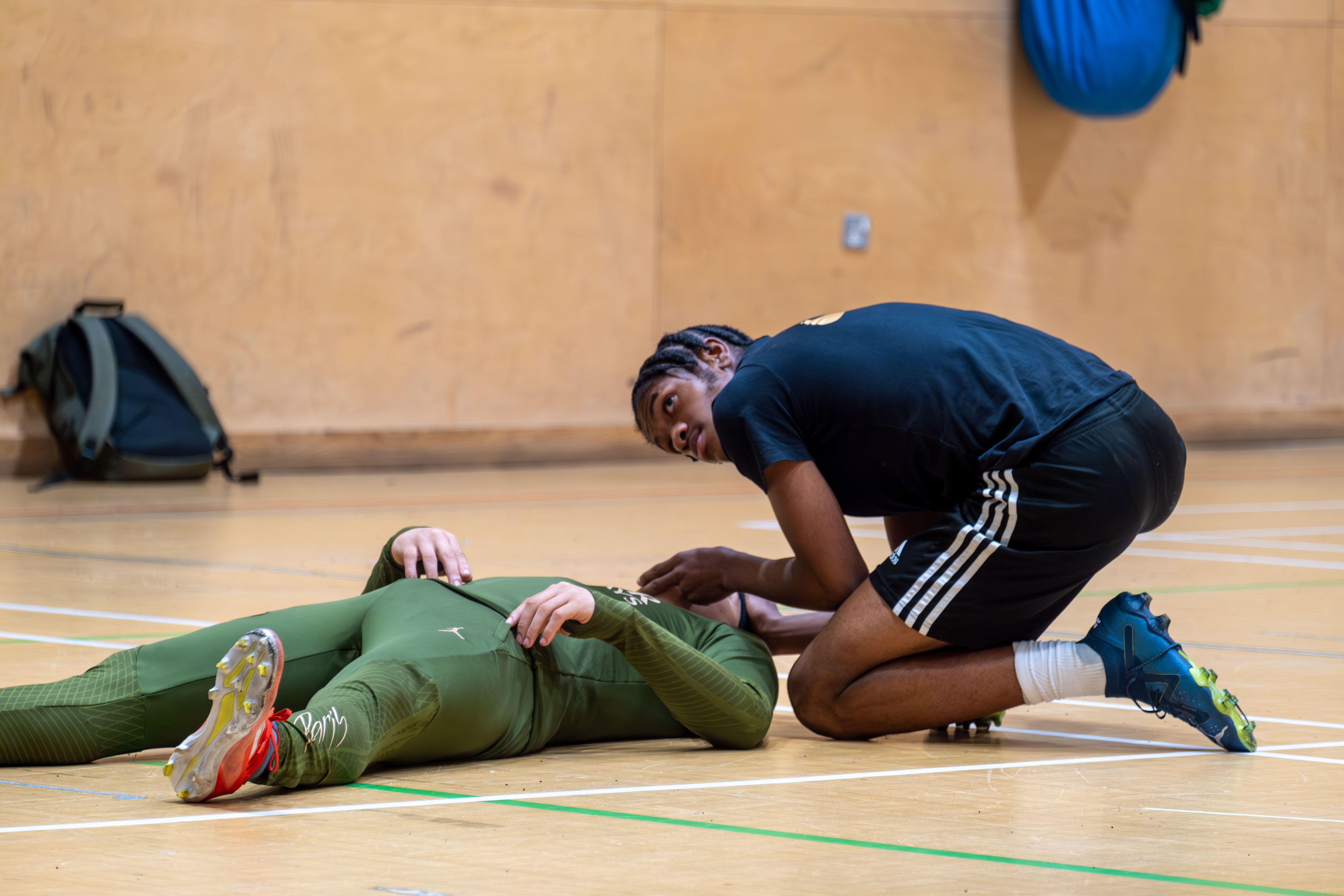 Participant checking vitals during Street First Aid workshop.