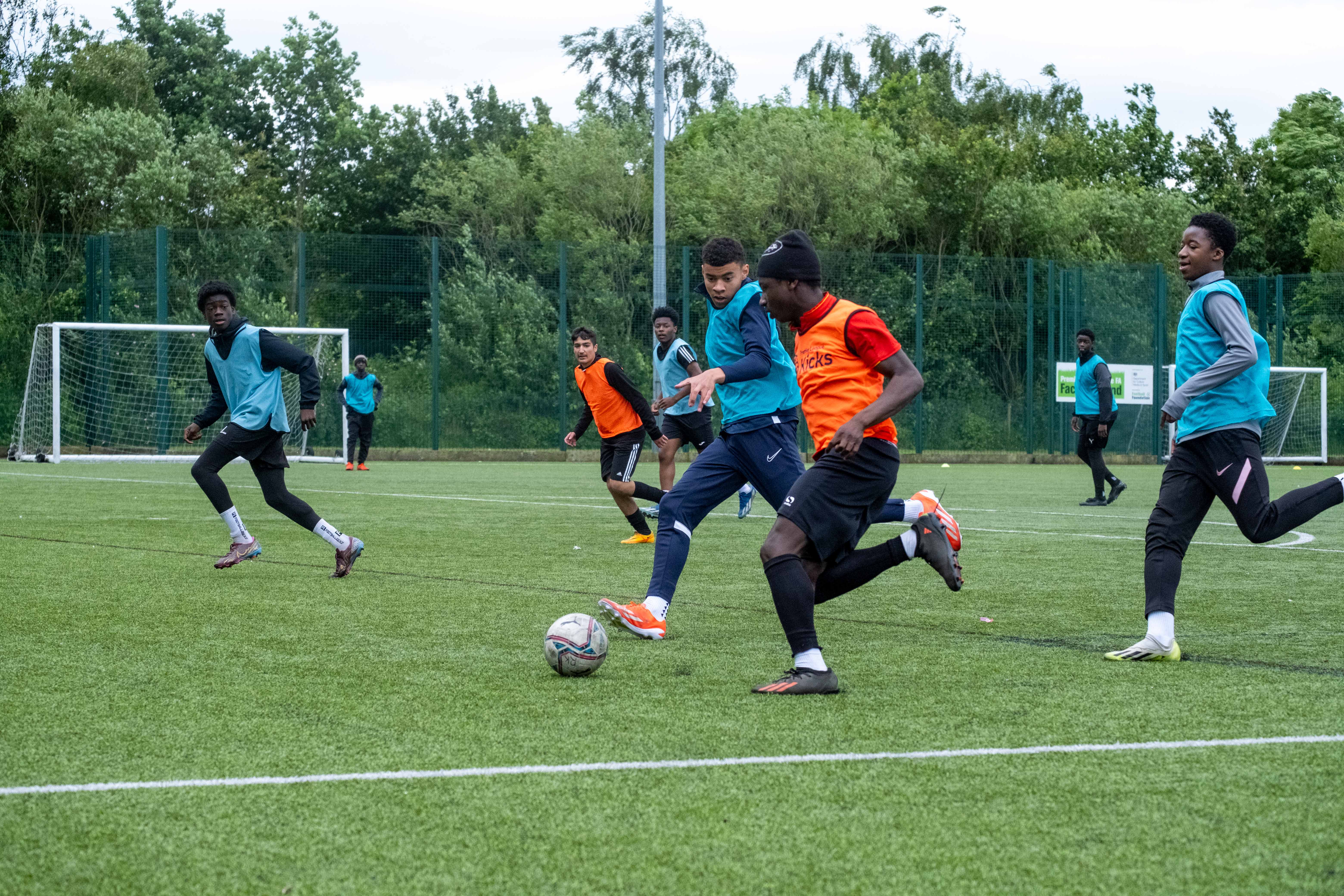 Aqua Blue v Orange, players chasing the ball.