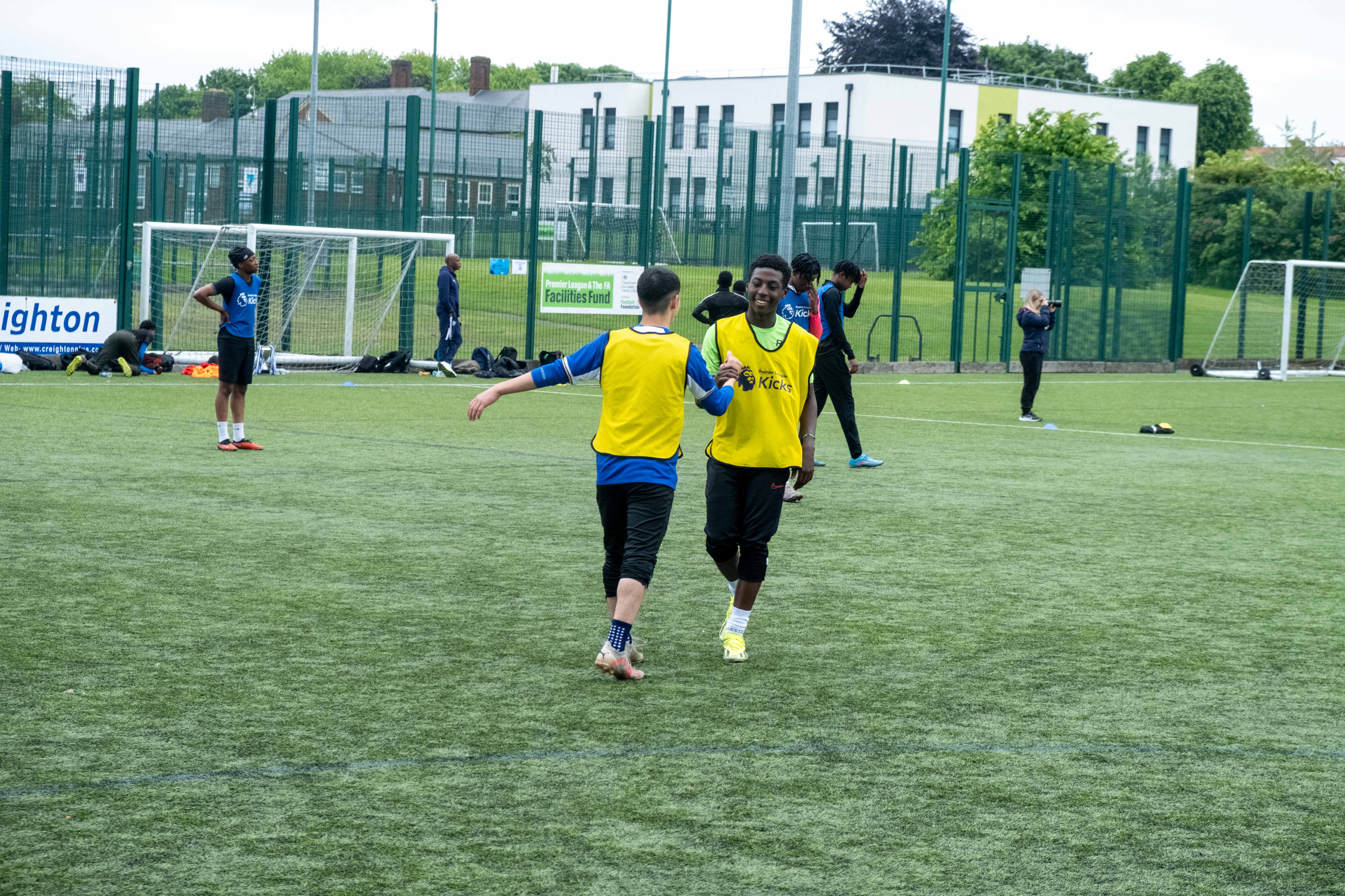 Teammate embrace after the game (yellow bibs)