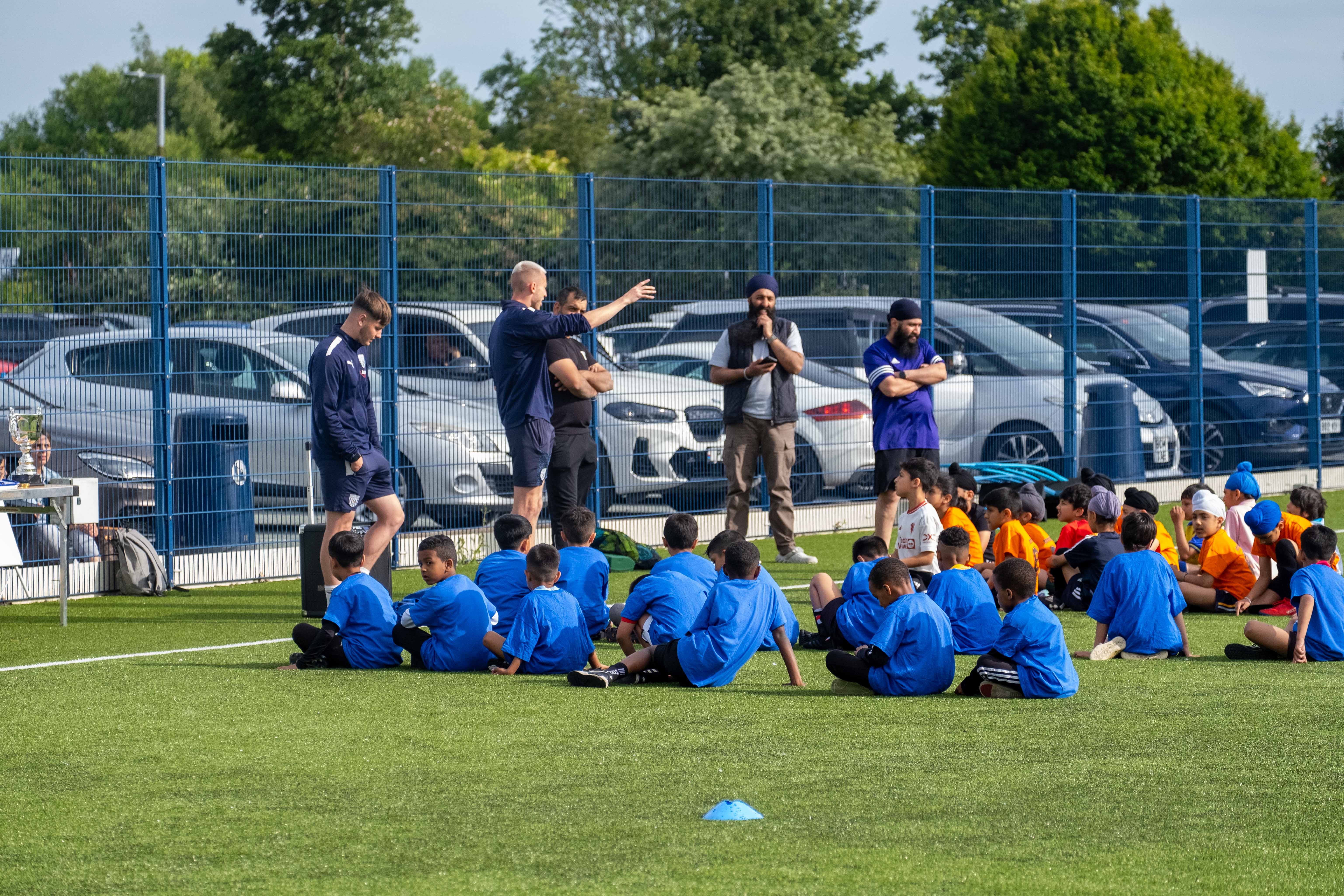 Participants at our South Asian Emerging Talent Festival receive instructions from The Albion Foundation coaches on the Academy pitch.