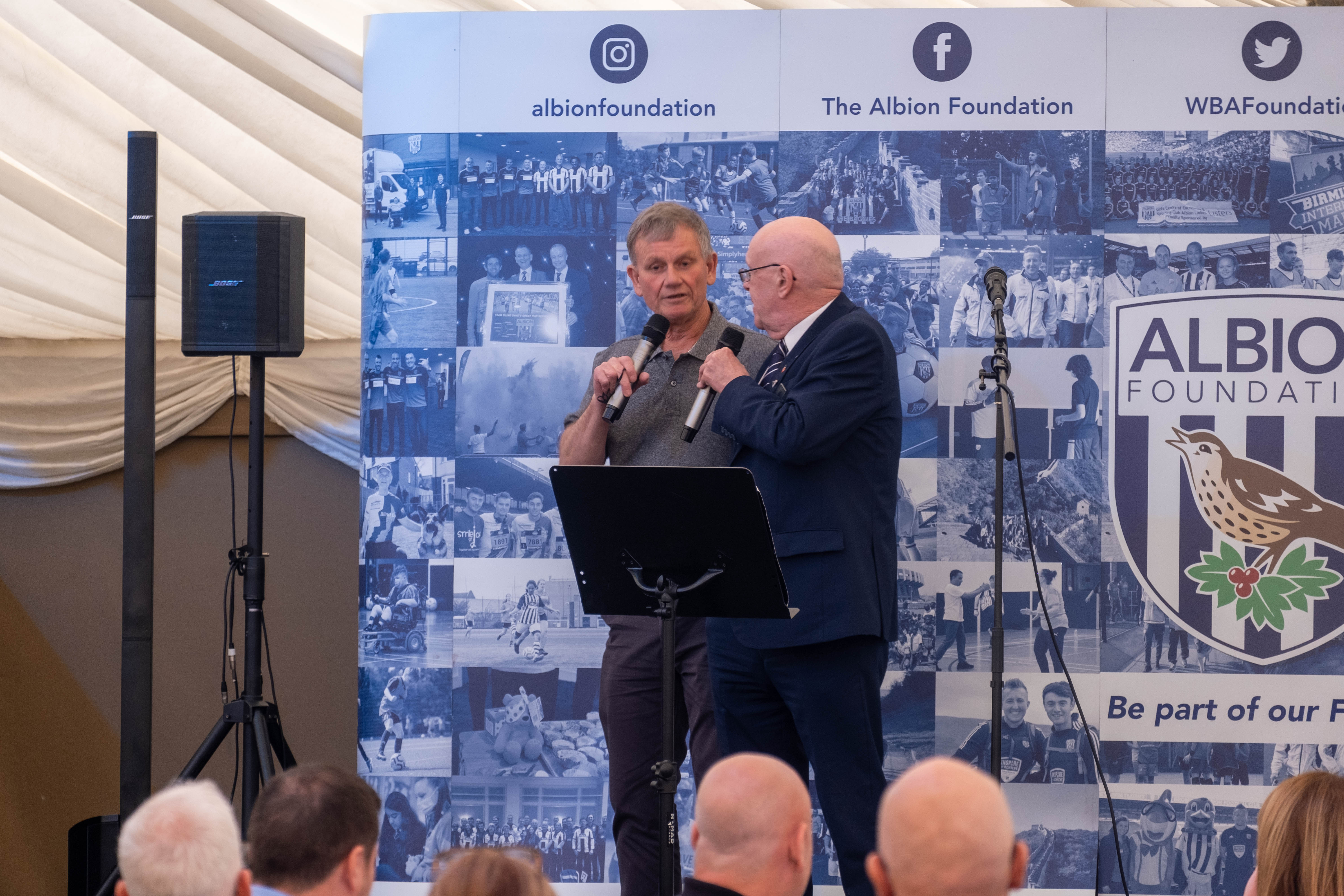 "Blind" Dave Heeley talks with John Homer on the stage.