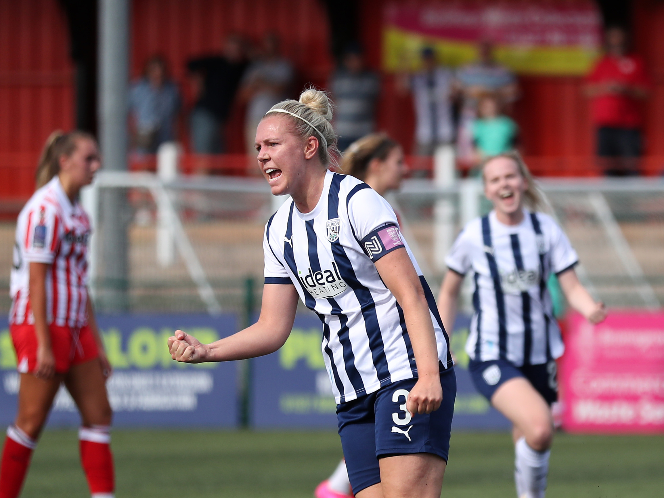 An image of Hannah George celebrating a goal